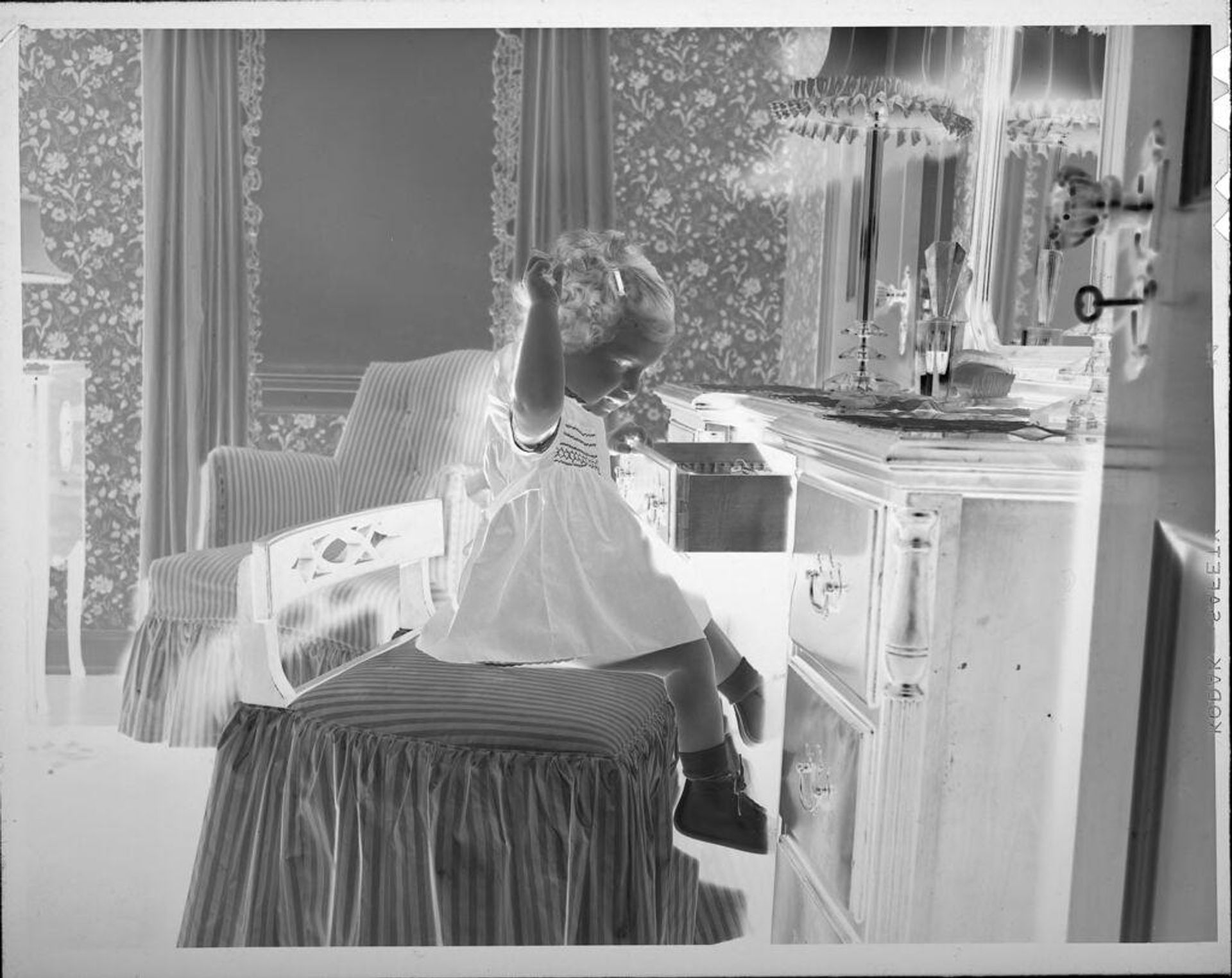 Untitled (little girl sitting in front of mirror) by Lucian and Mary Brown