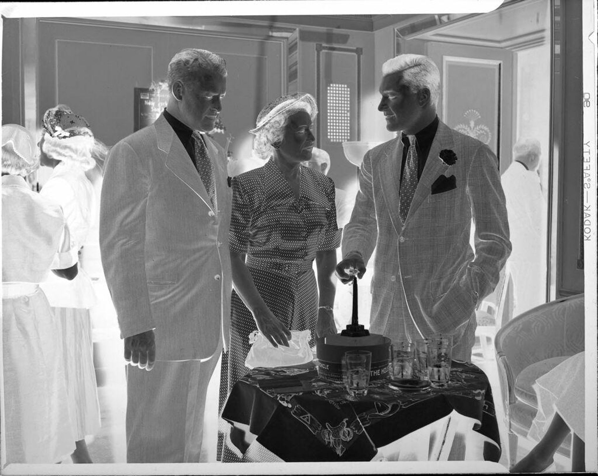 Untitled (men and woman at party) by Peter James Studio