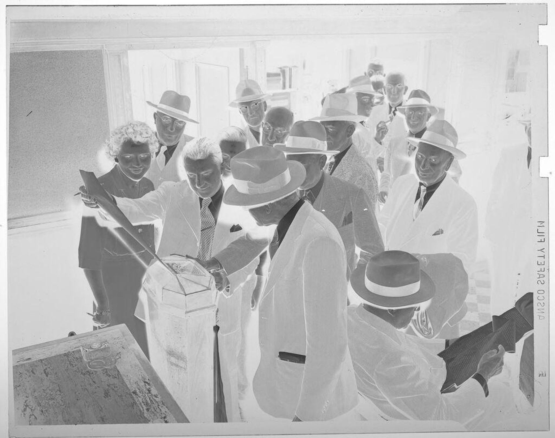 Untitled (VE Day: crowd of people looking at paper) by Jack Gould