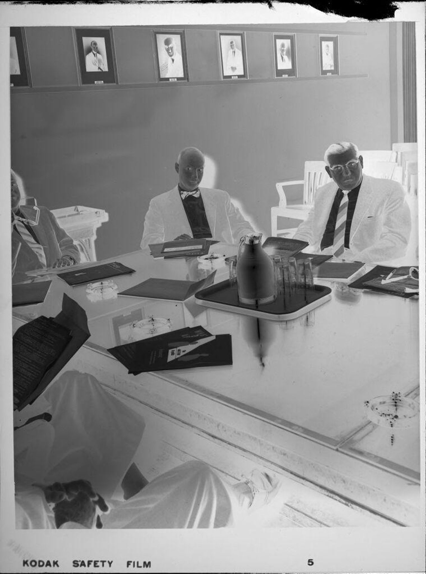 Untitled (men having business meeting around table) by Peter James Studio