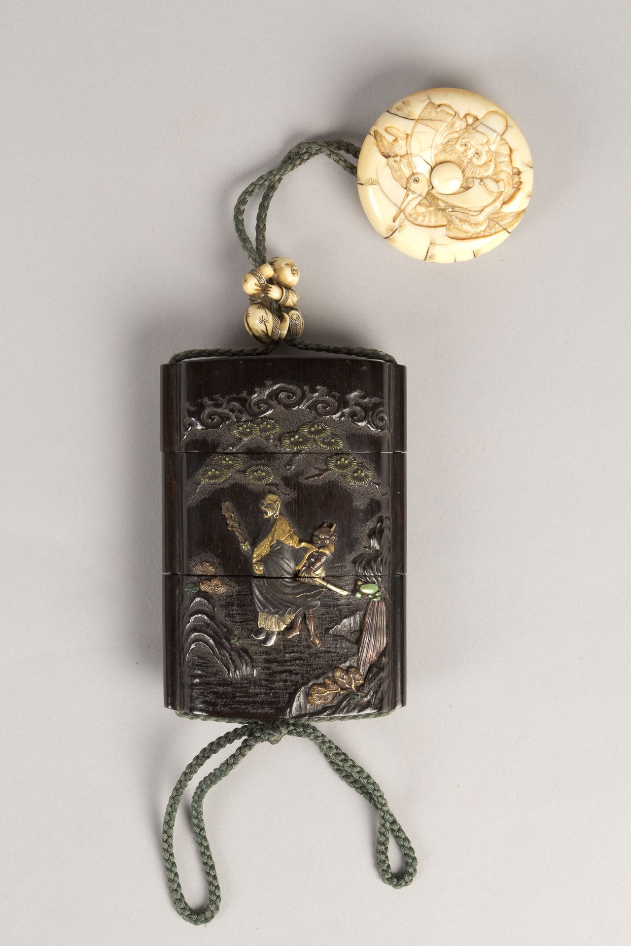 Case (Inrō) with Design of Ōni (Demon) Standing Behind Cloak of Arhat (obverse); Fly Whisk (Hossu) beneath Pine Tree (reverse) by Tokoku