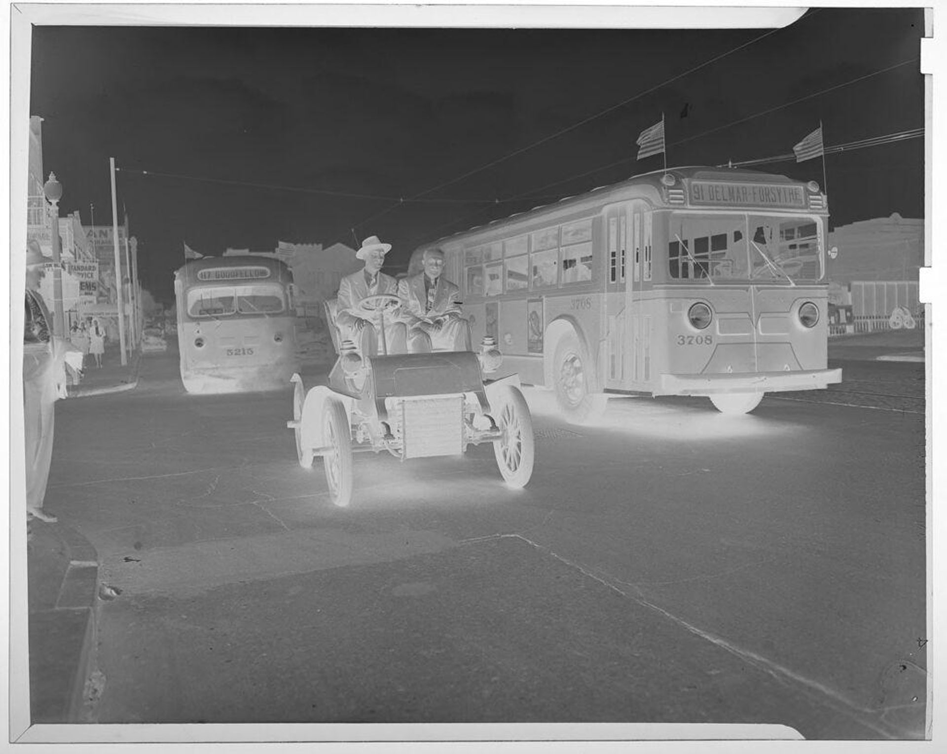 Untitled (men driving old car down city street next to bus) by Jack Gould
