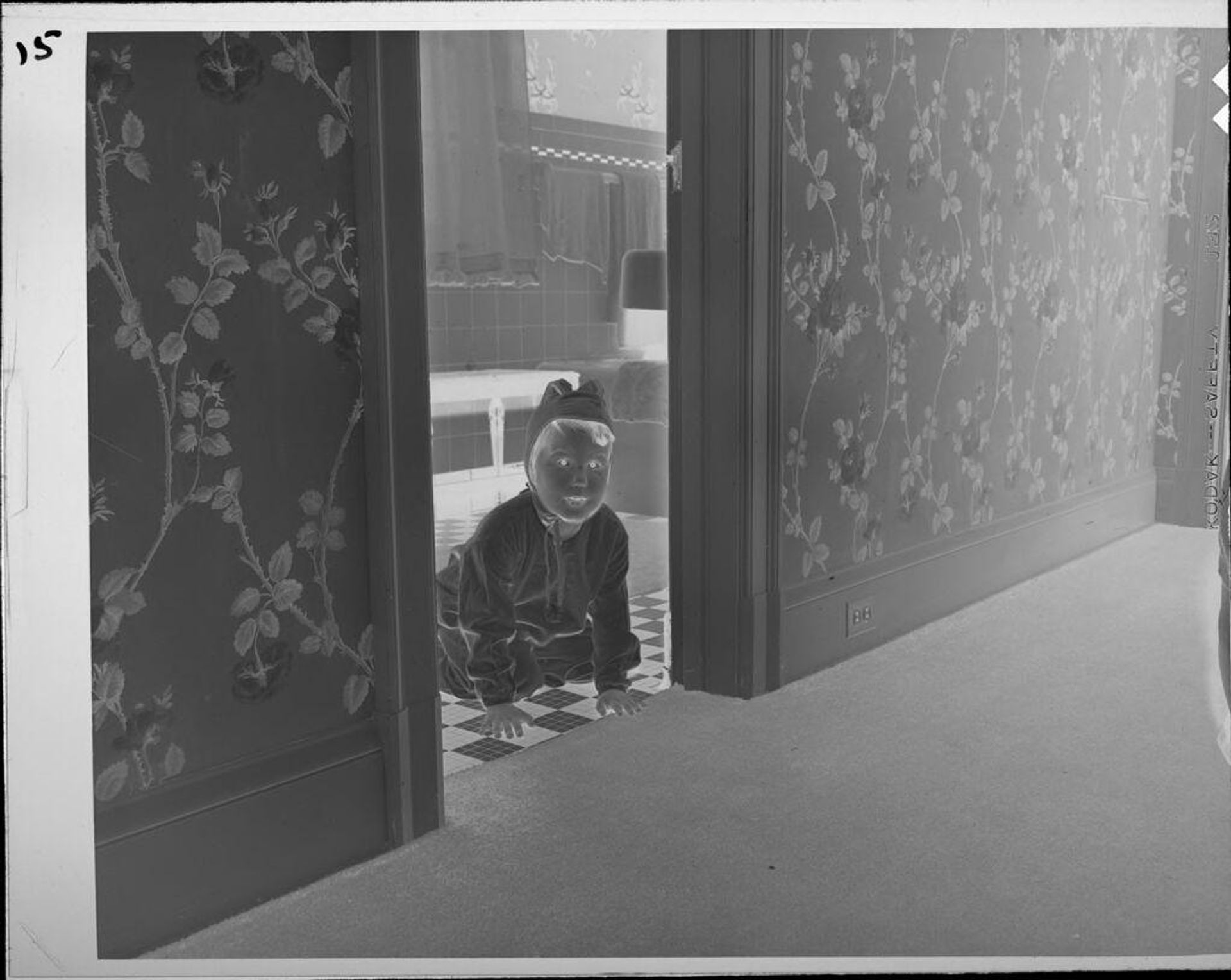 Untitled (child on floor looking out of doorway) by Lucian and Mary Brown