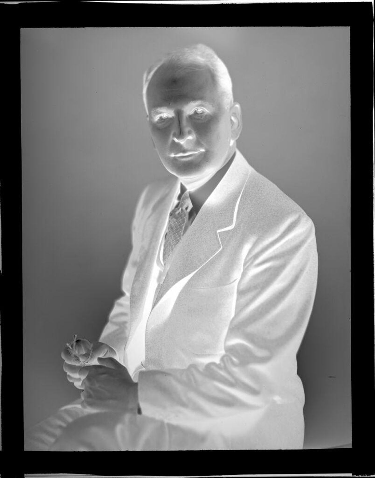 Untitled (portrait of man holding eyeglasses) by John Howell