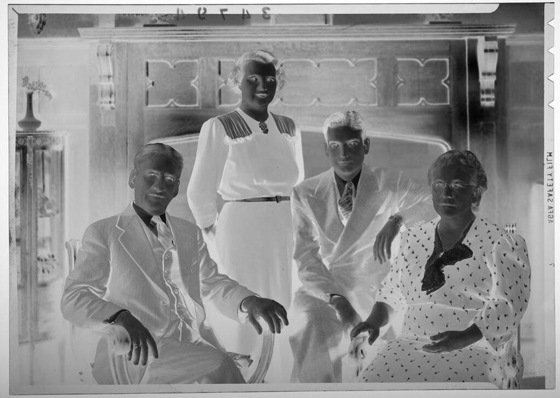 Untitled (family with son and daughter posed in front of living room fireplace) by Martin Schweig