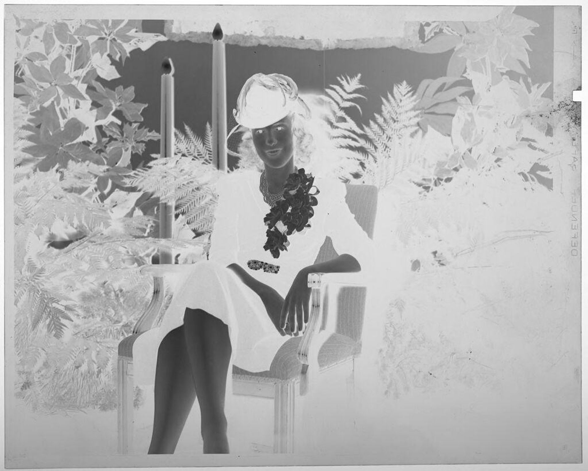 Untitled (young woman posed in chair wearing black suit and hat) by Martin Schweig