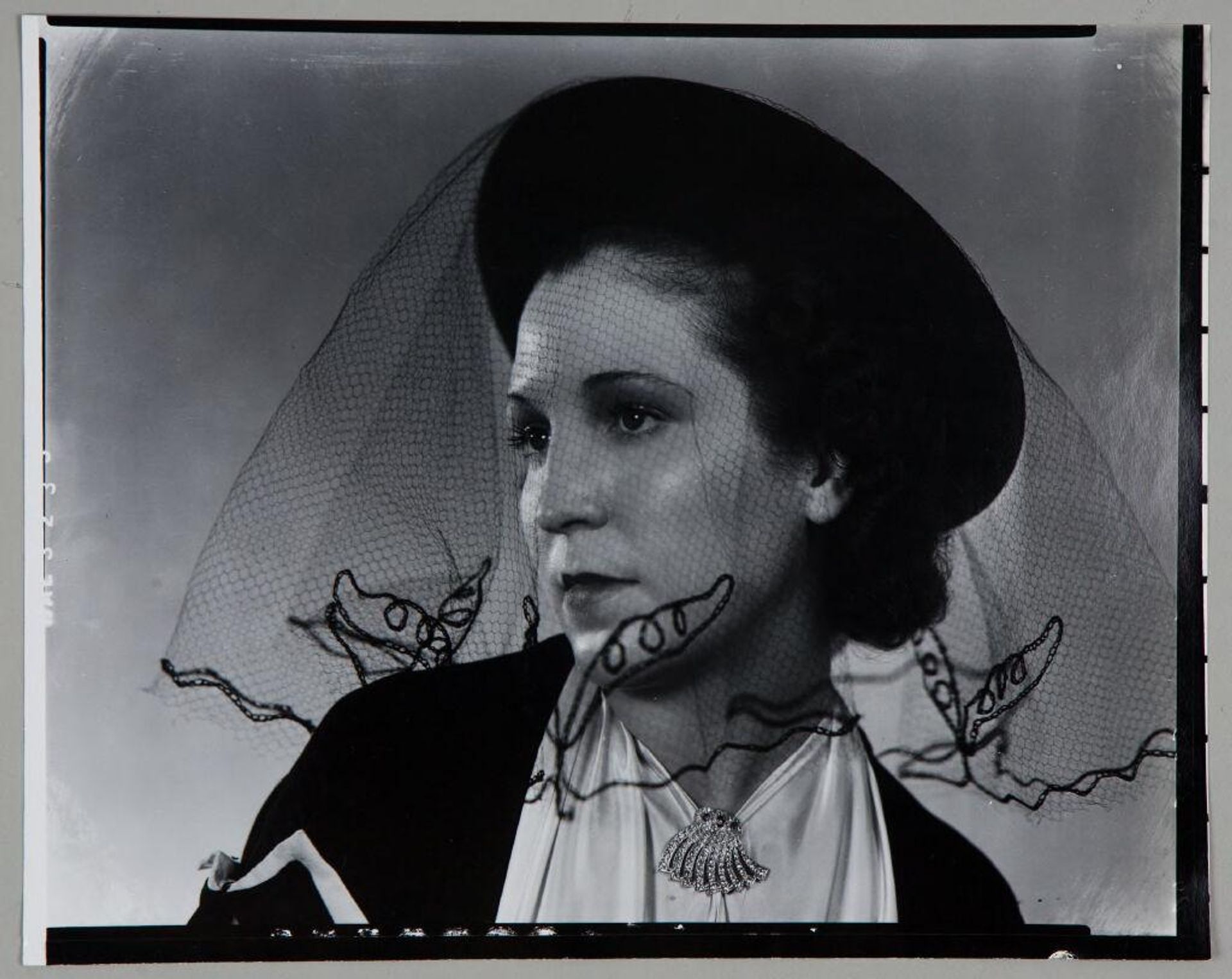 Untitled (portrait of woman in hat with black veil, looking left) by Paul Gittings