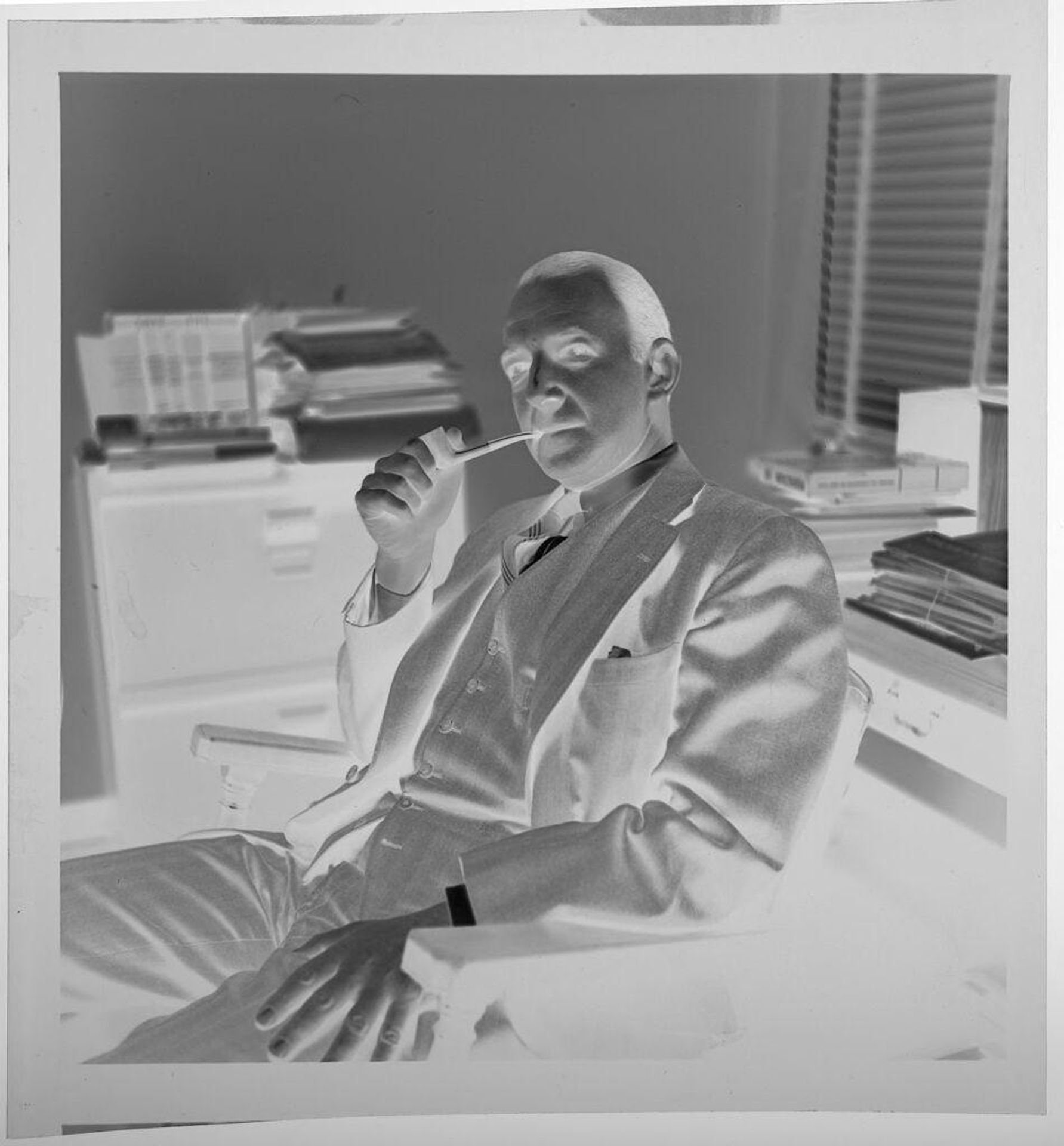 Untitled (man sitting at desk and smoking a pipe) by Jack Gould