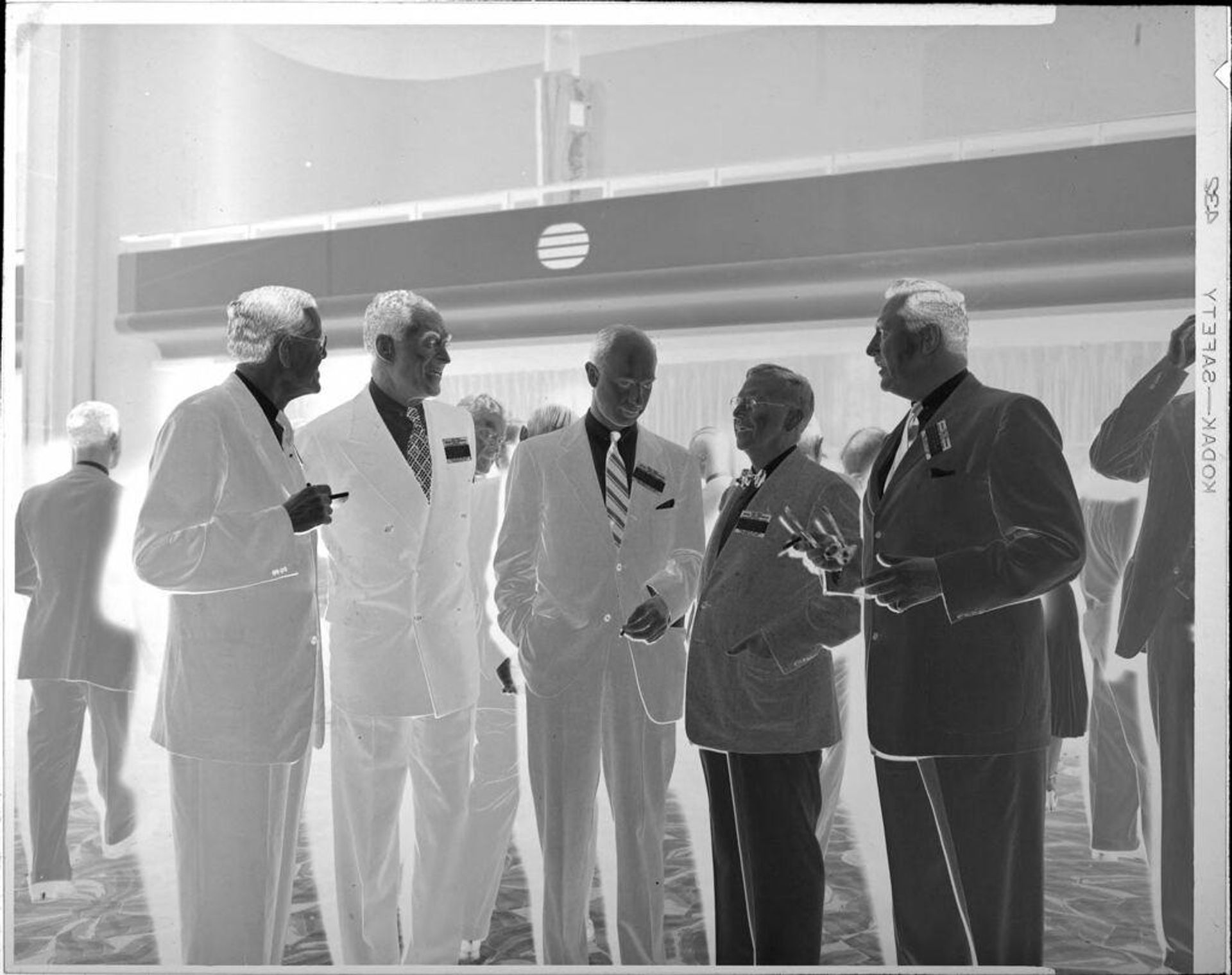 Untitled (five men wearing nametags) by Peter James Studio