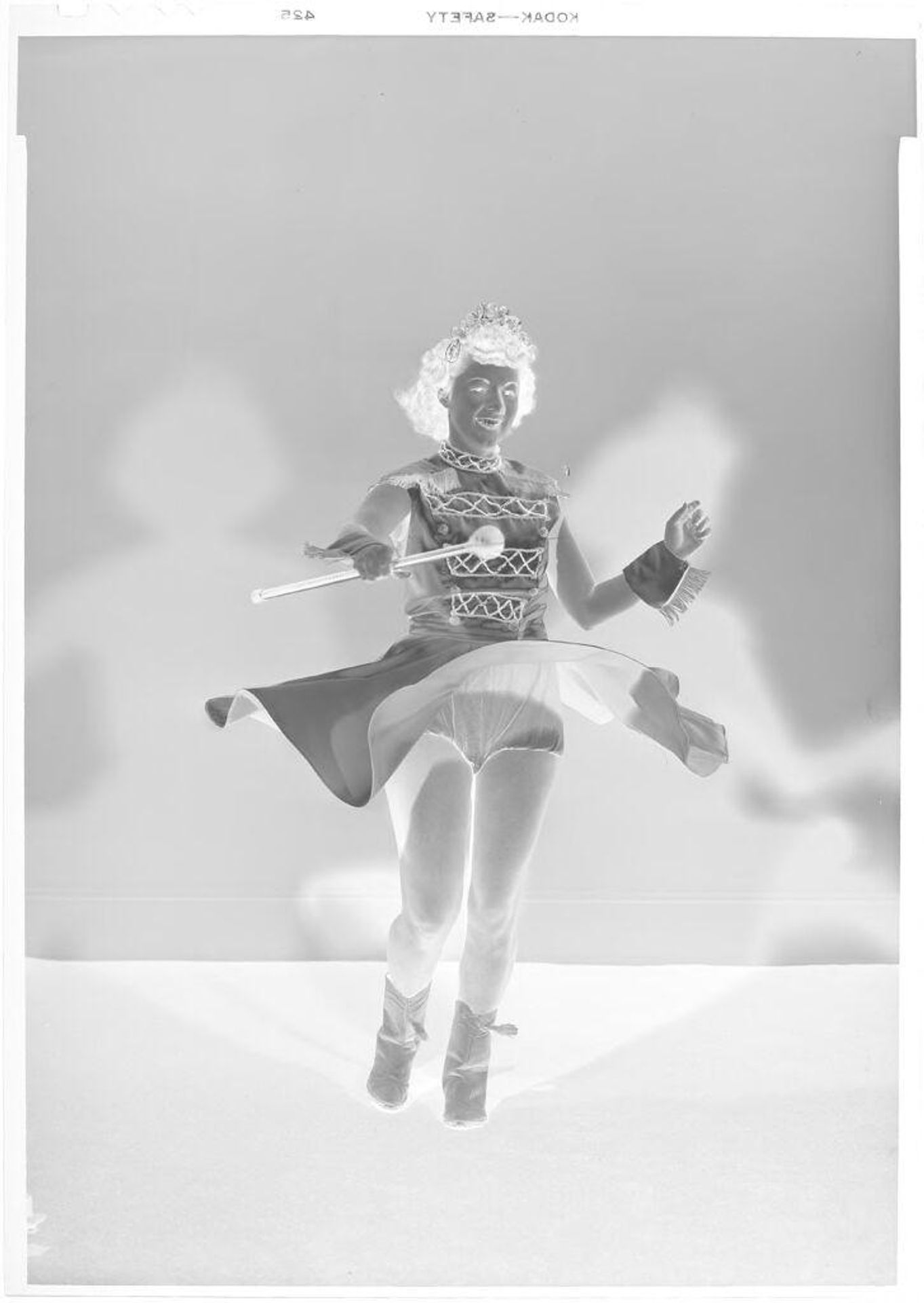 Untitled (drum majorette, twirling seen from front) by John Deusing
