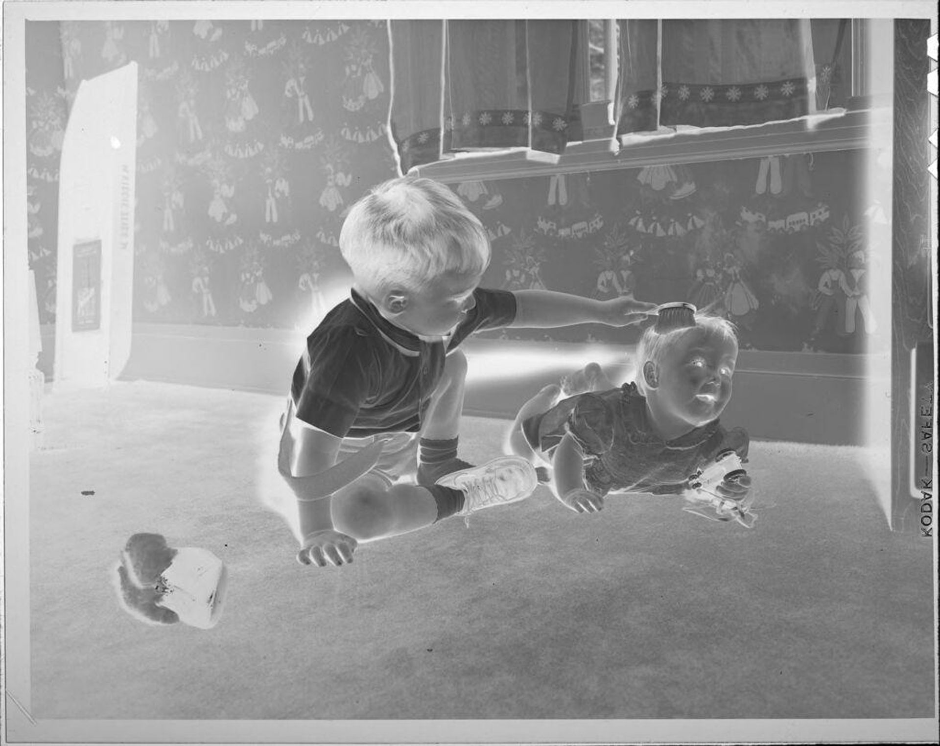 Untitled (little boy brushing baby's hair) by Lucian and Mary Brown
