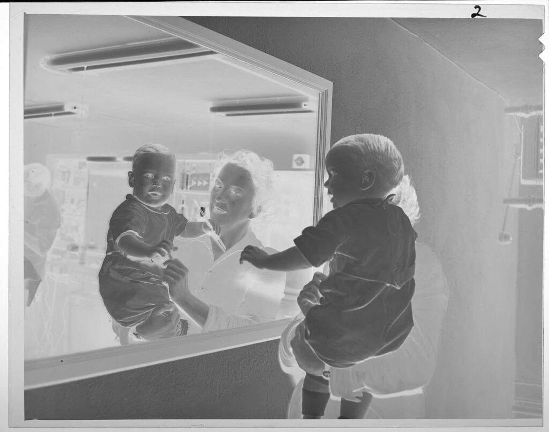 Untitled (woman with baby in front of large mirror) by Lucian and Mary Brown