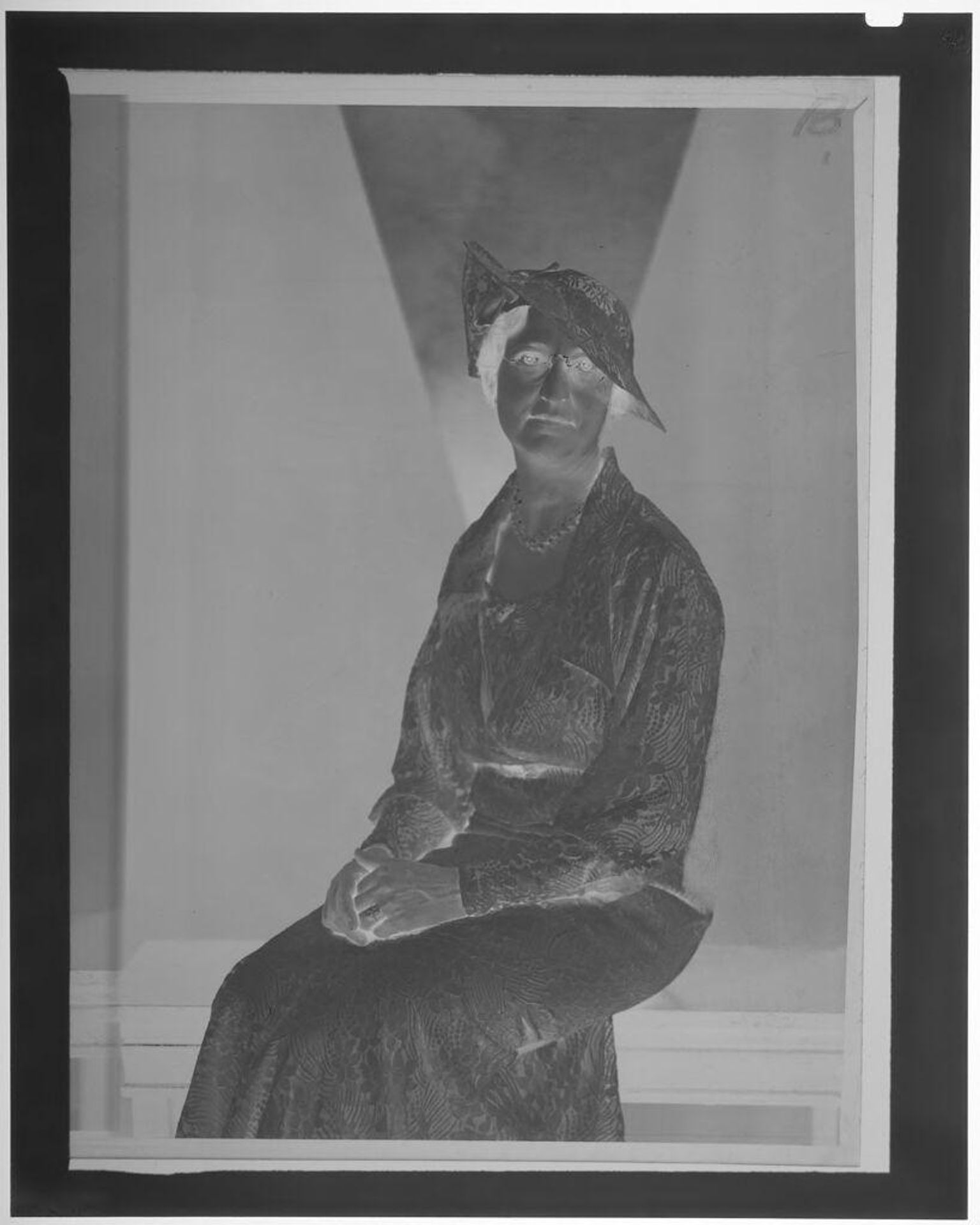 Untitled (middle-aged woman with glasses posed in flower print dress and hat) by Martin Schweig