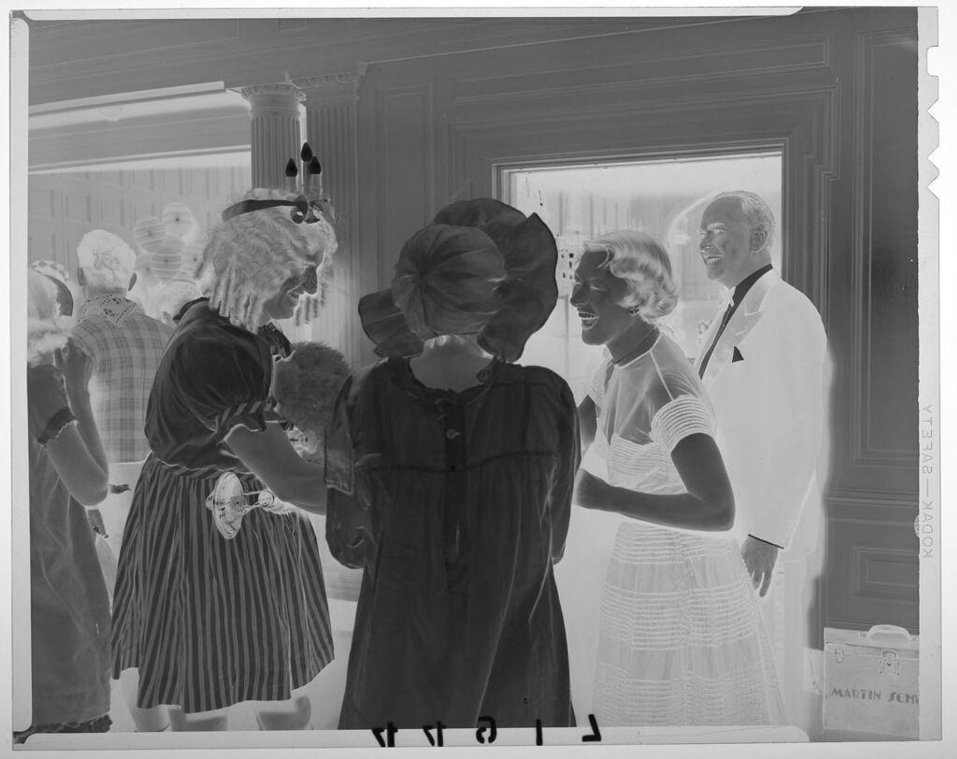 Untitled (couple in costumes chatting with couple in formal wear at party) by Martin Schweig
