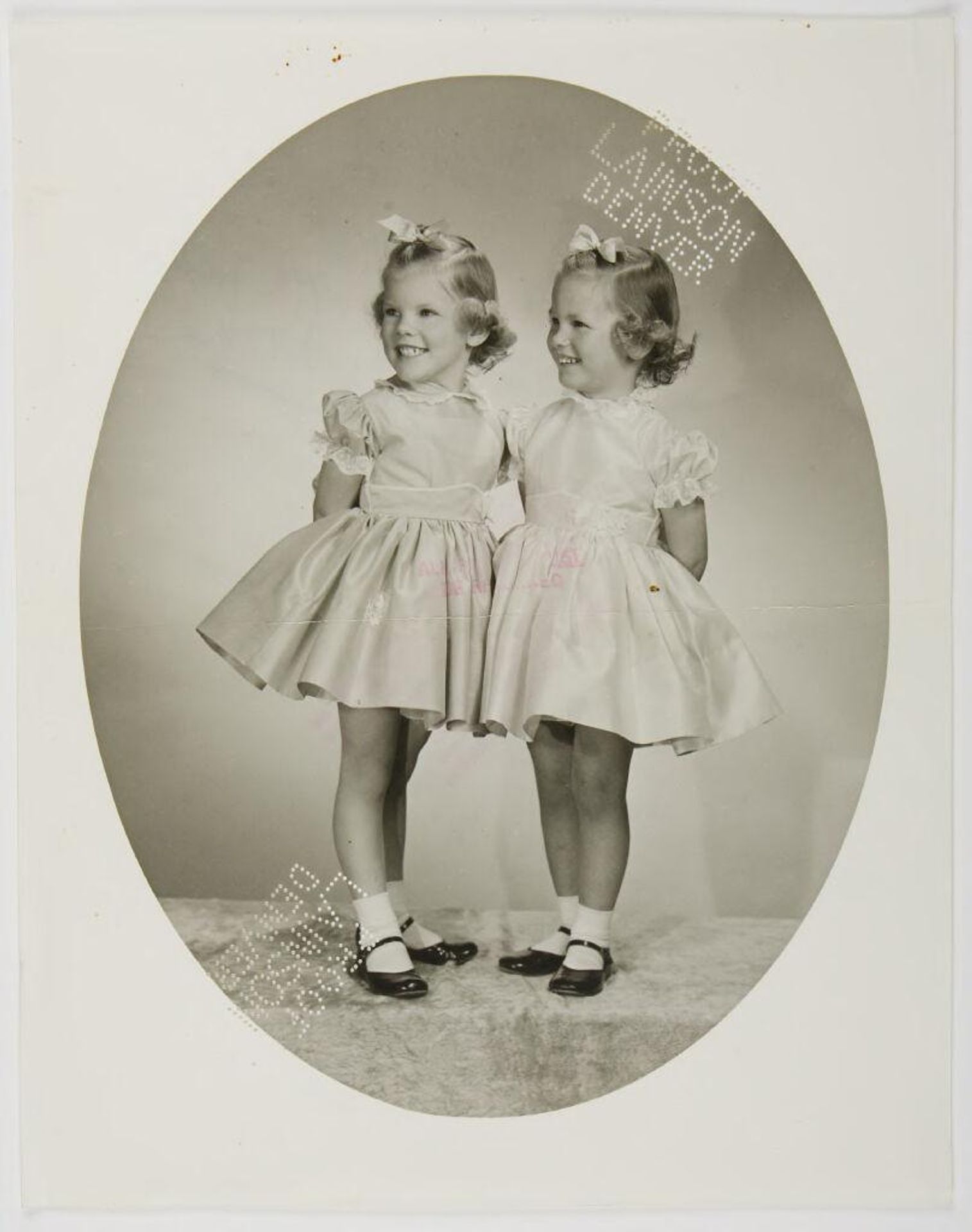 Untitled (two girls in dresses, image in vignette) by Lainson Studios