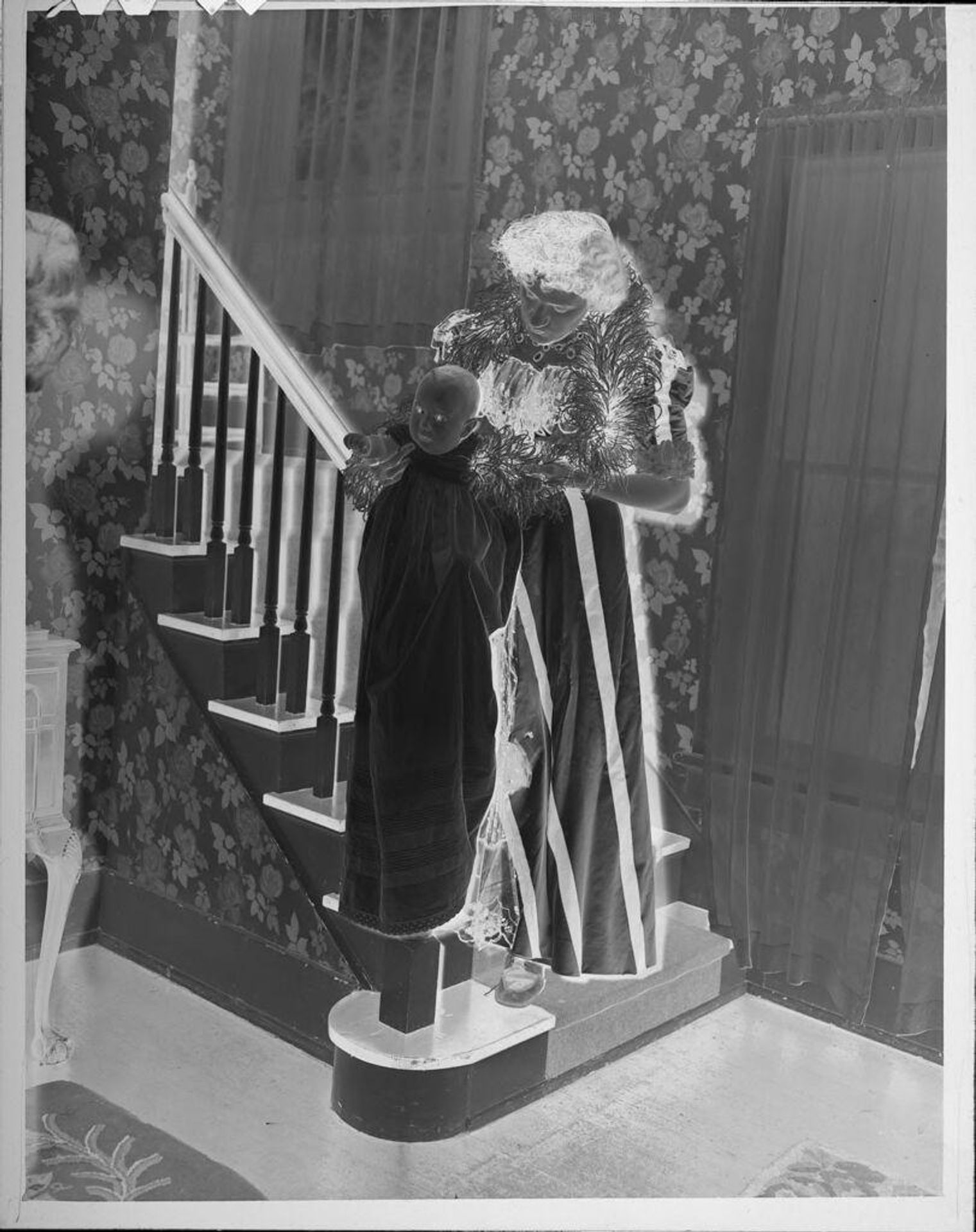 Untitled (woman holding baby in christening dress) by Lucian and Mary Brown