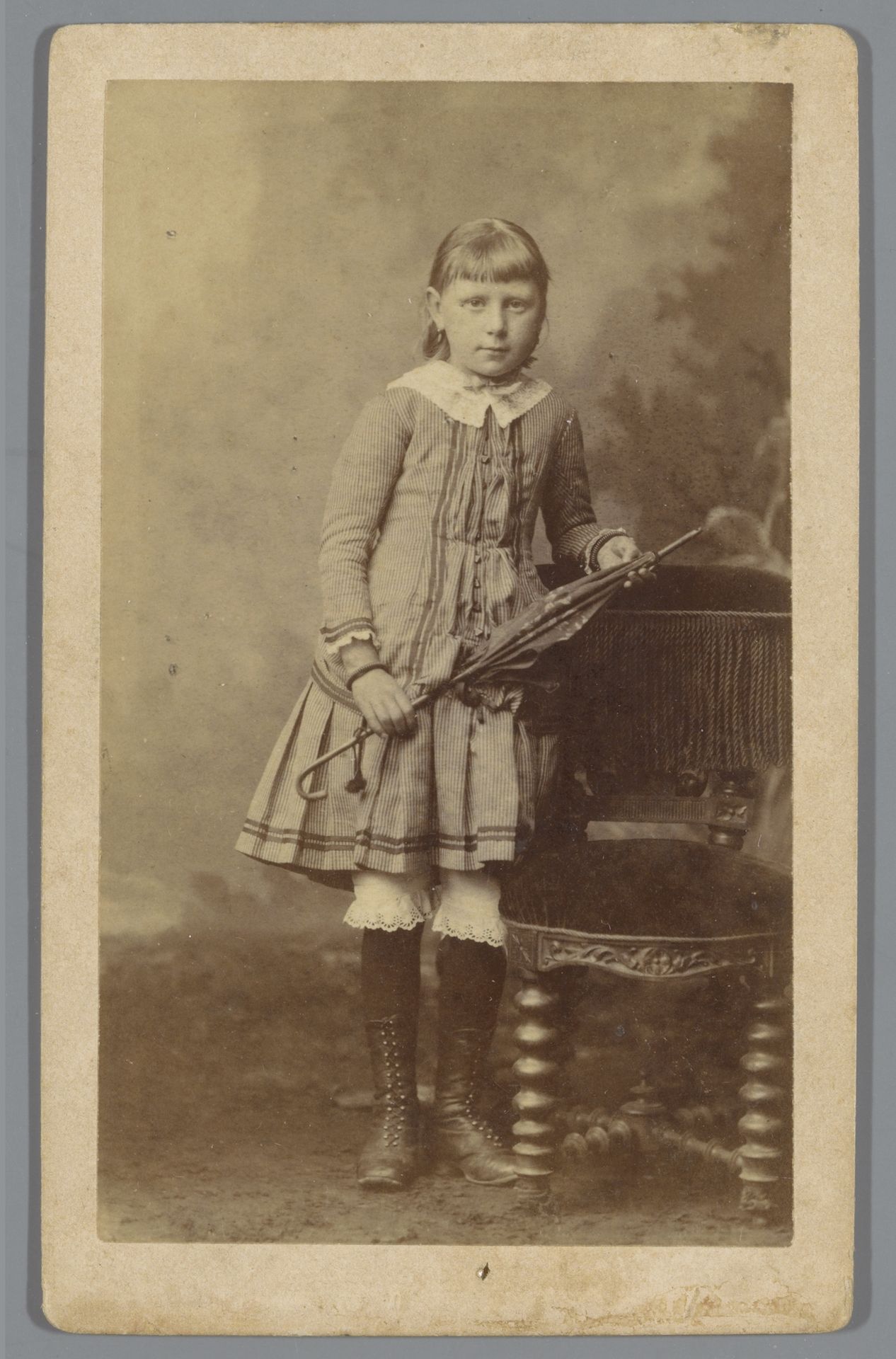Portret van een onbekend meisje, leunend tegen een stoel met een paraplu in de hand by B.J. Pottjewijd