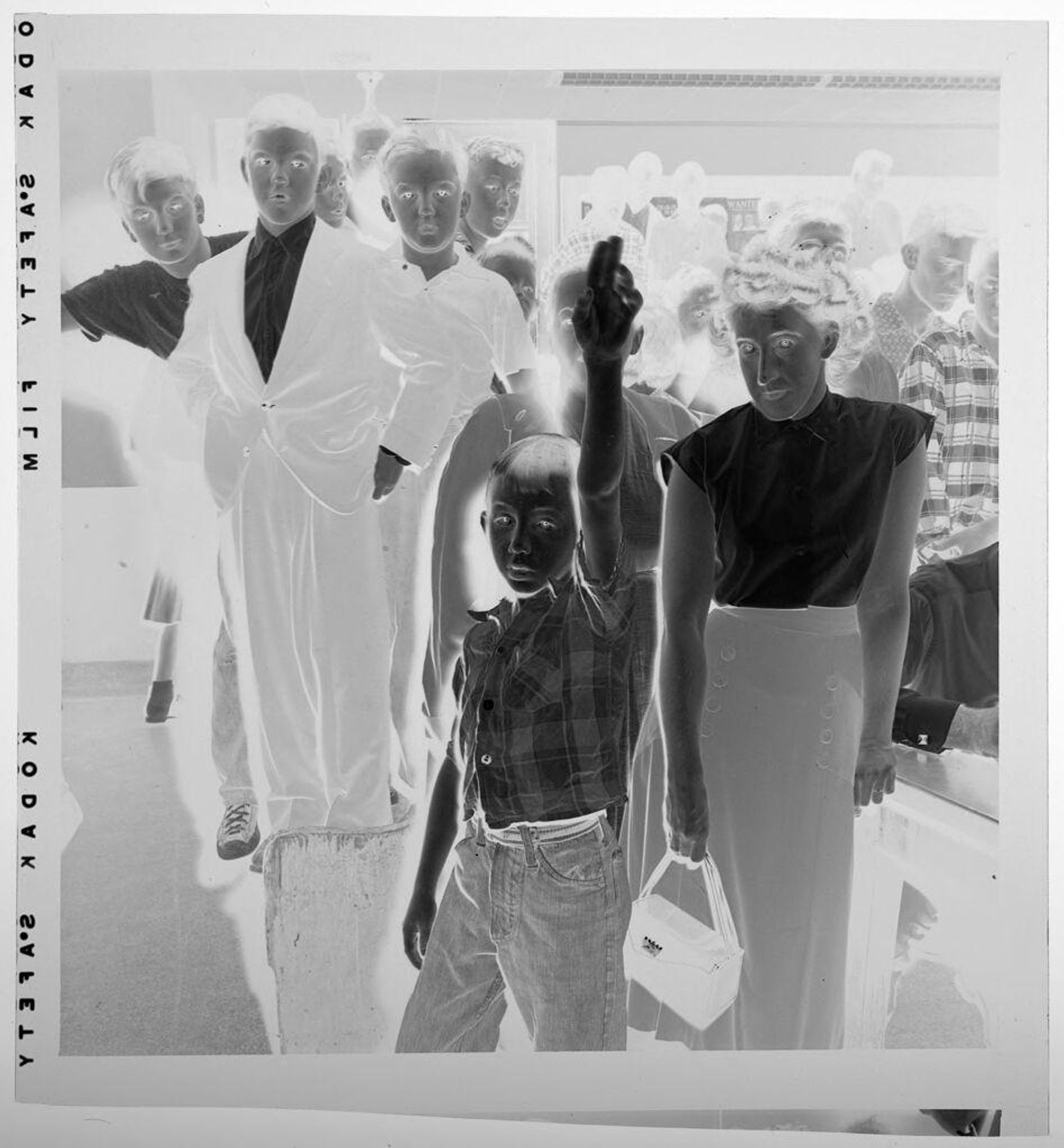 Untitled (boy raising arm in front of crowd) by Jack Gould