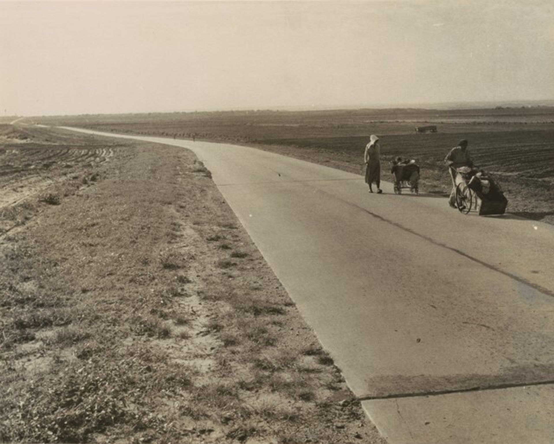 Flood refugee family near Memphis, Texas, are bound for the lower Rio Grande Valley, where they hope to pick cotton. They are from Arkansas by Dorothea Lange