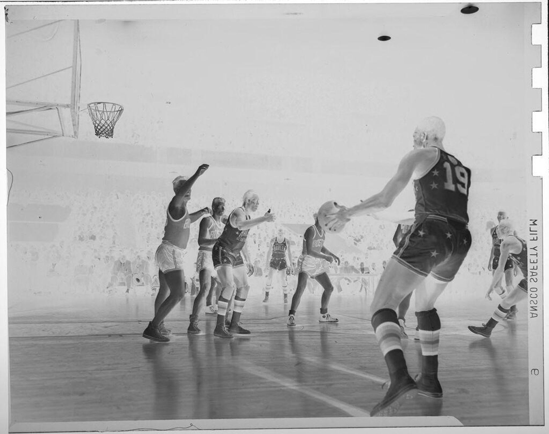Untitled (basketball players playing on court; man in front passing the ball, Harlem Globe Trotters) by Jack Gould