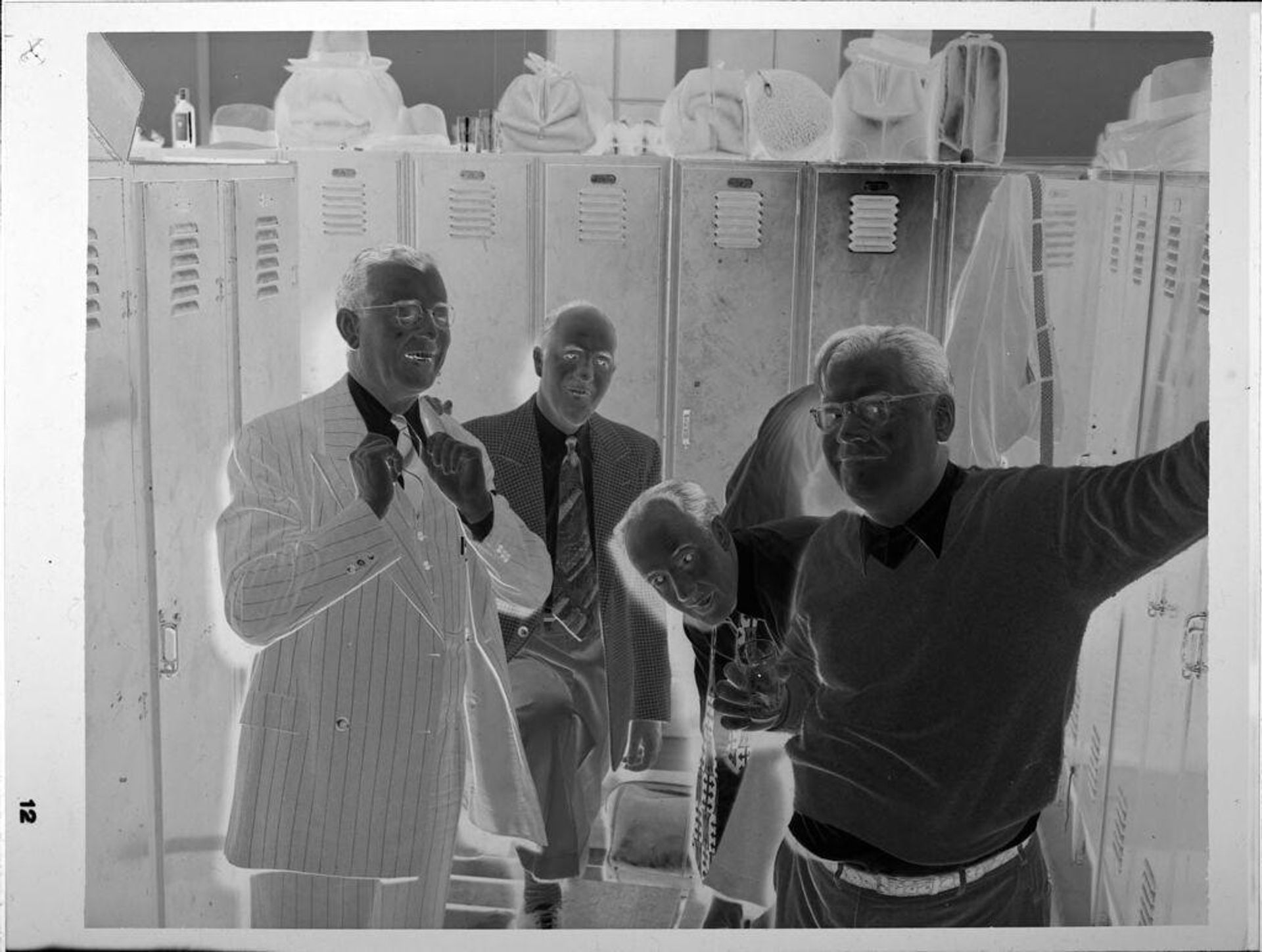 Untitled (four men in locker room) by John Howell