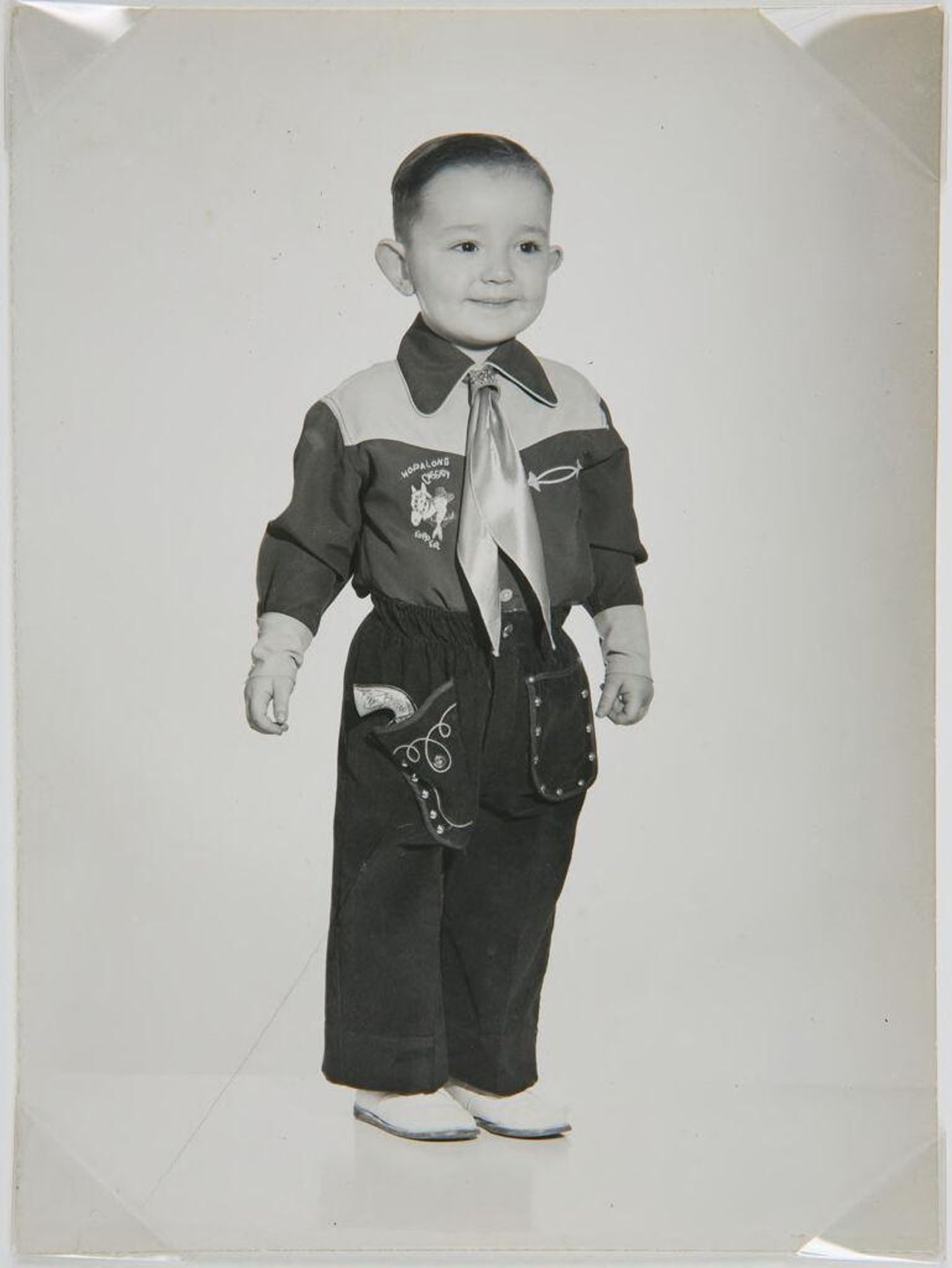 Untitled (little boy in cowboy outfit) by John Deusing