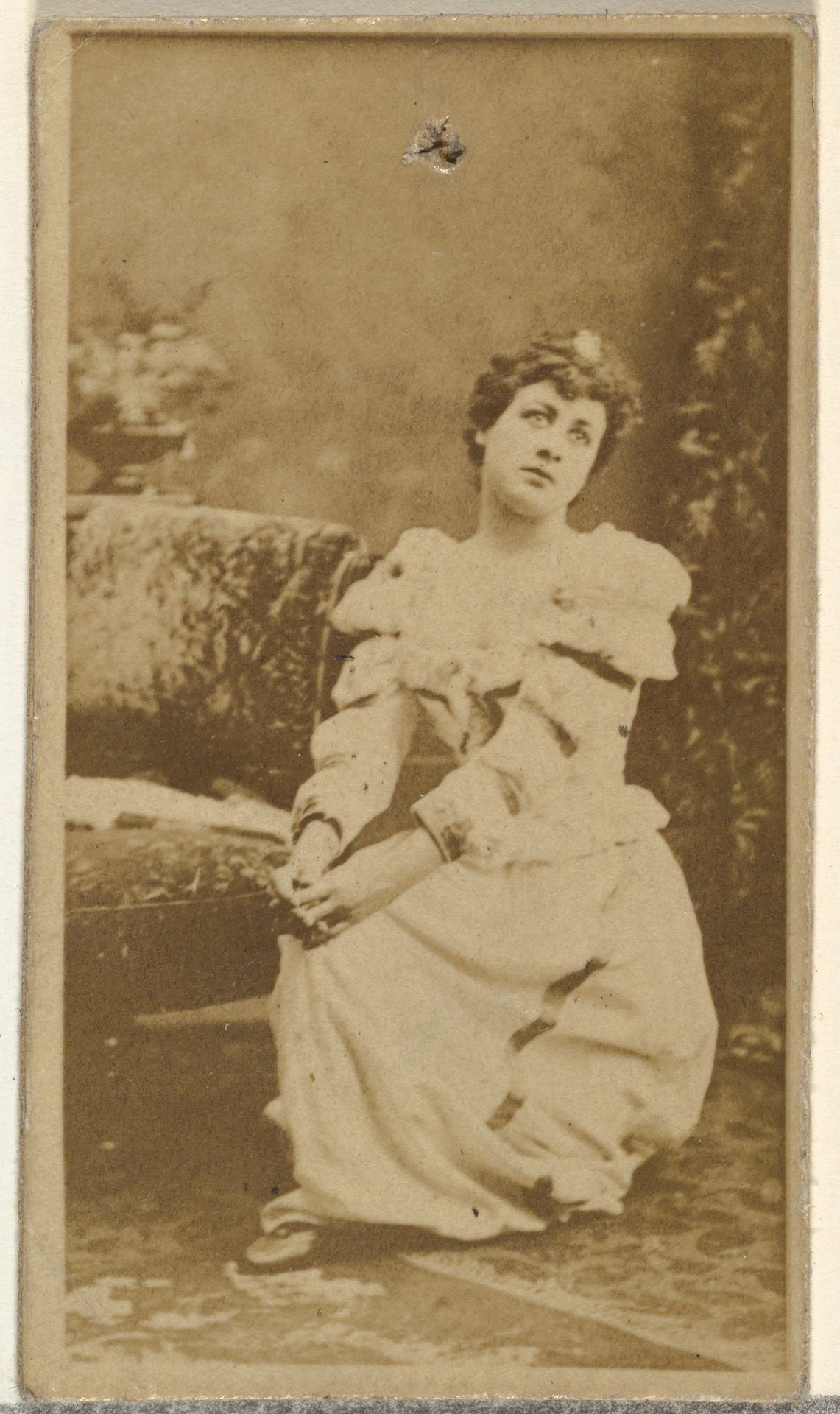 [Seated actress wearing dress with ruffled sleeves], from the Actors and Actresses series (N145-8) issued by Duke Sons & Co. to promote Duke Cigarettes by W. Duke, Sons & Co.