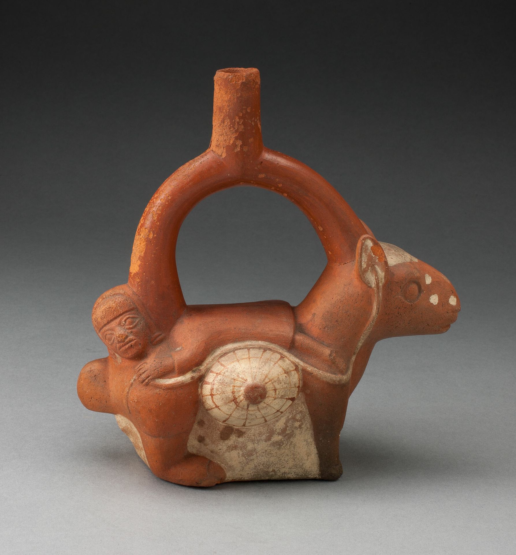 Stirrup Spout Vessel in the Form of a Woman Laying on the Back of a Llama by Moche