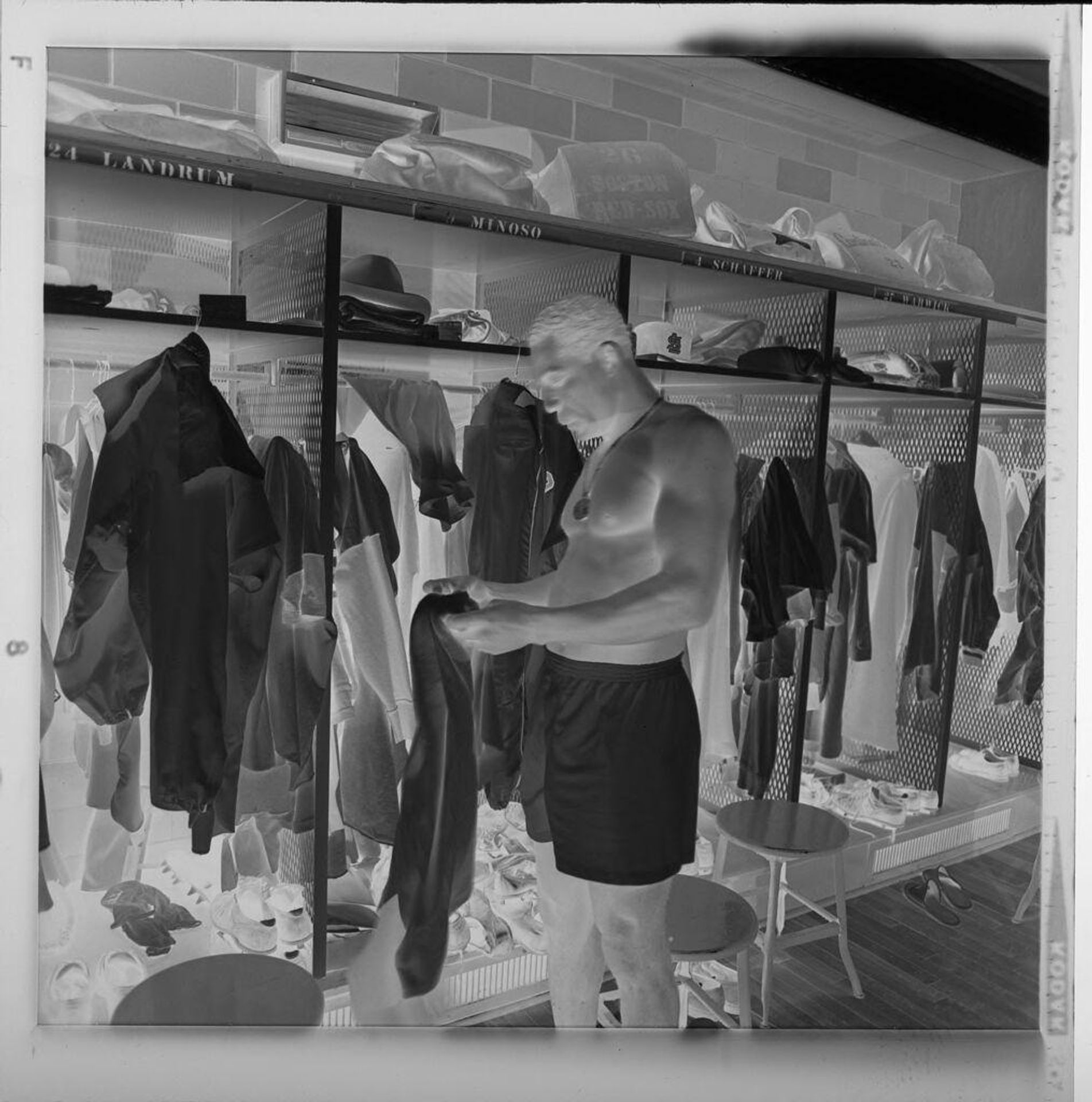 Untitled (Cardinal baseball player Minnie Minoso in locker room, changing shirt) by Jack Gould
