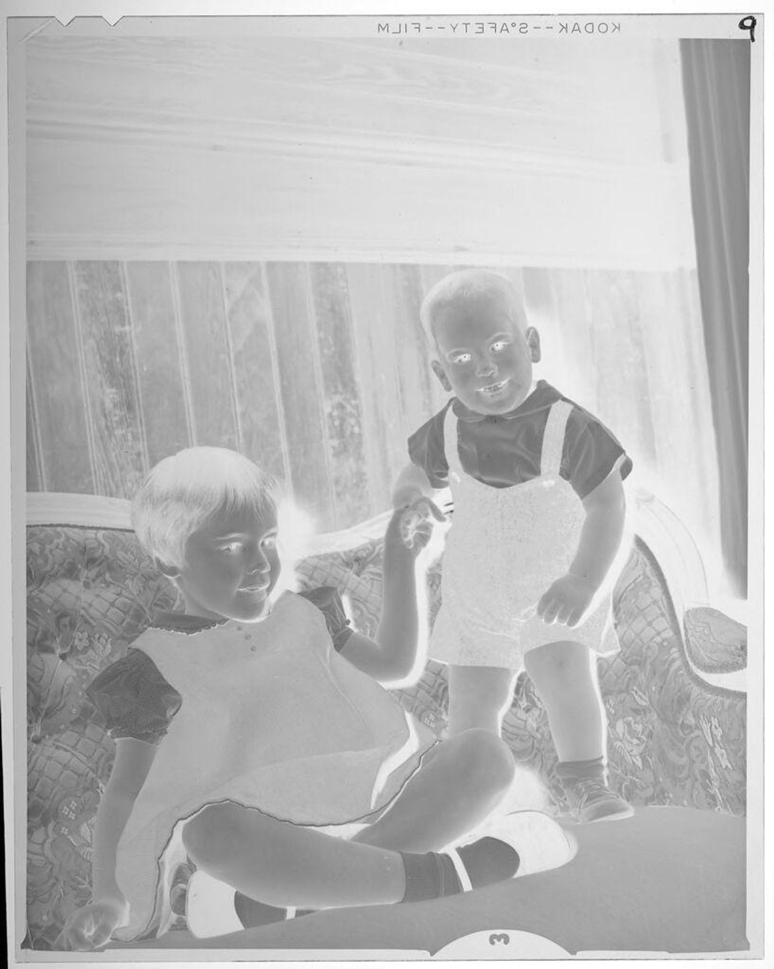 Untitled (girl and boy on couch) by Lucian and Mary Brown
