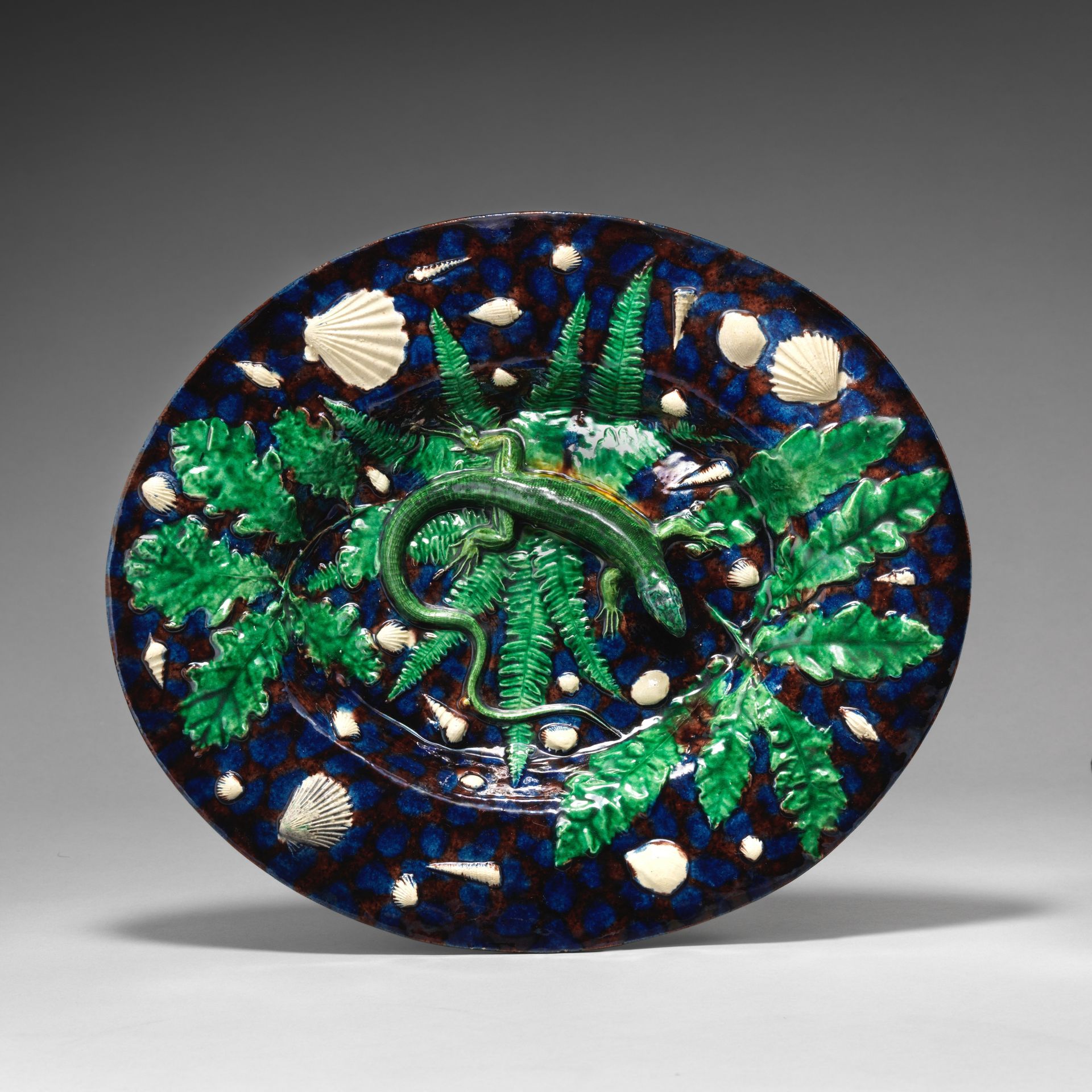Small plate with lizard, shells, and blue and purple background by Georges Pull