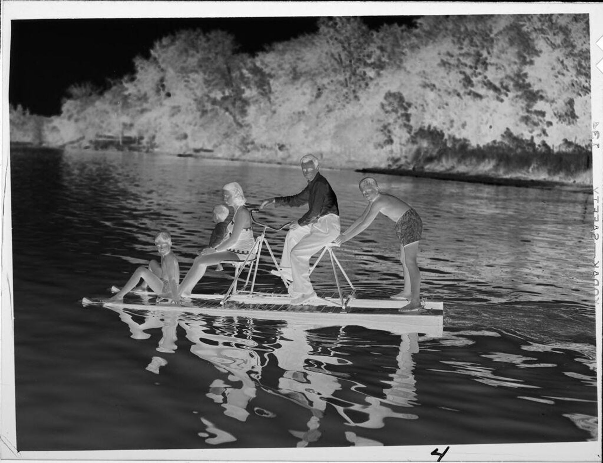 Untitled (family on bicycle-powered raft on lake) by Lucian and Mary Brown