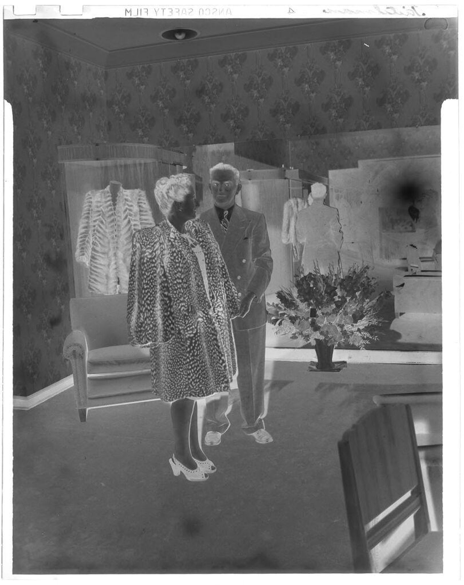 Untitled (woman trying on fur coat) by John Deusing