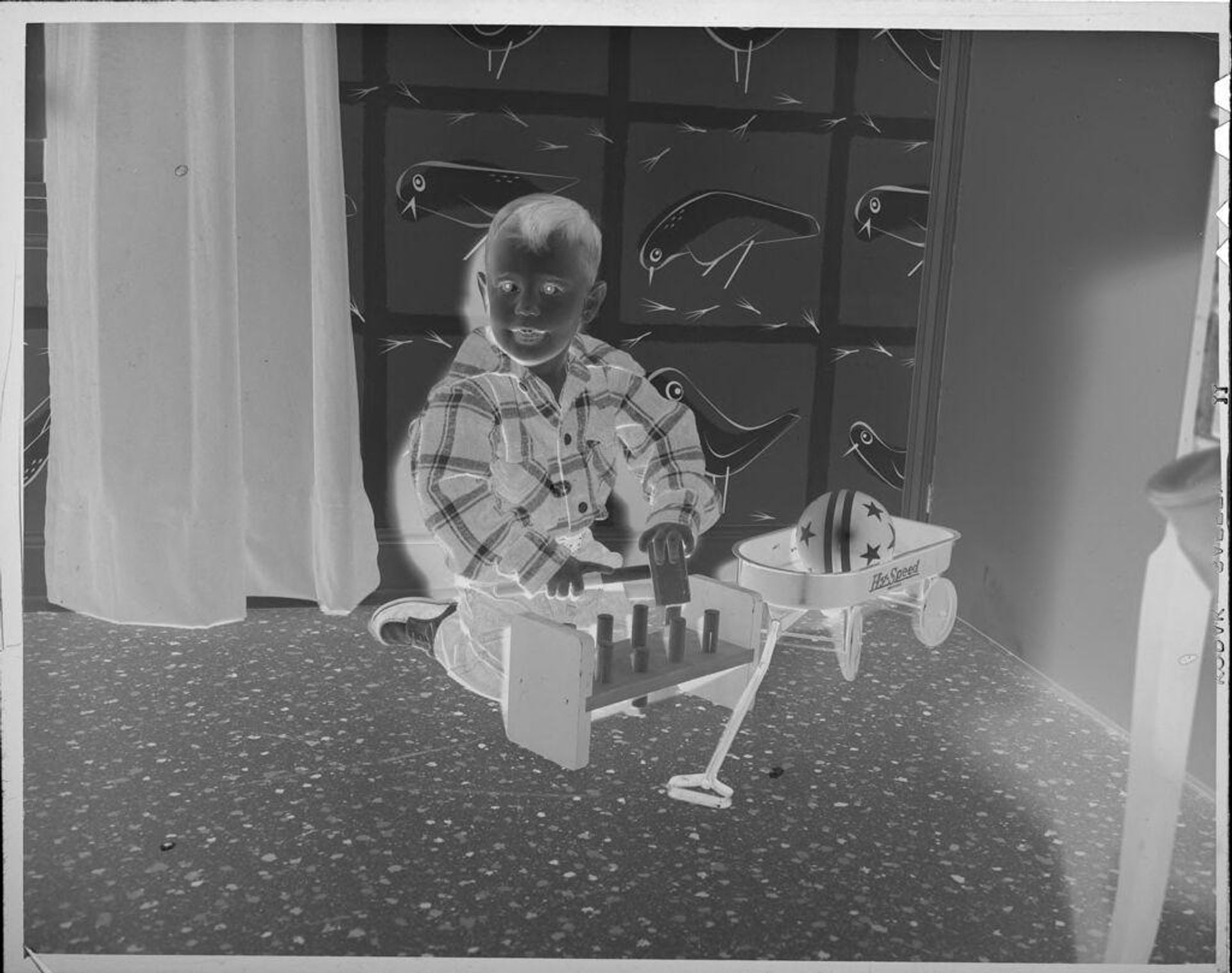 Untitled (boy playing with blocks and wagon) by Lucian and Mary Brown