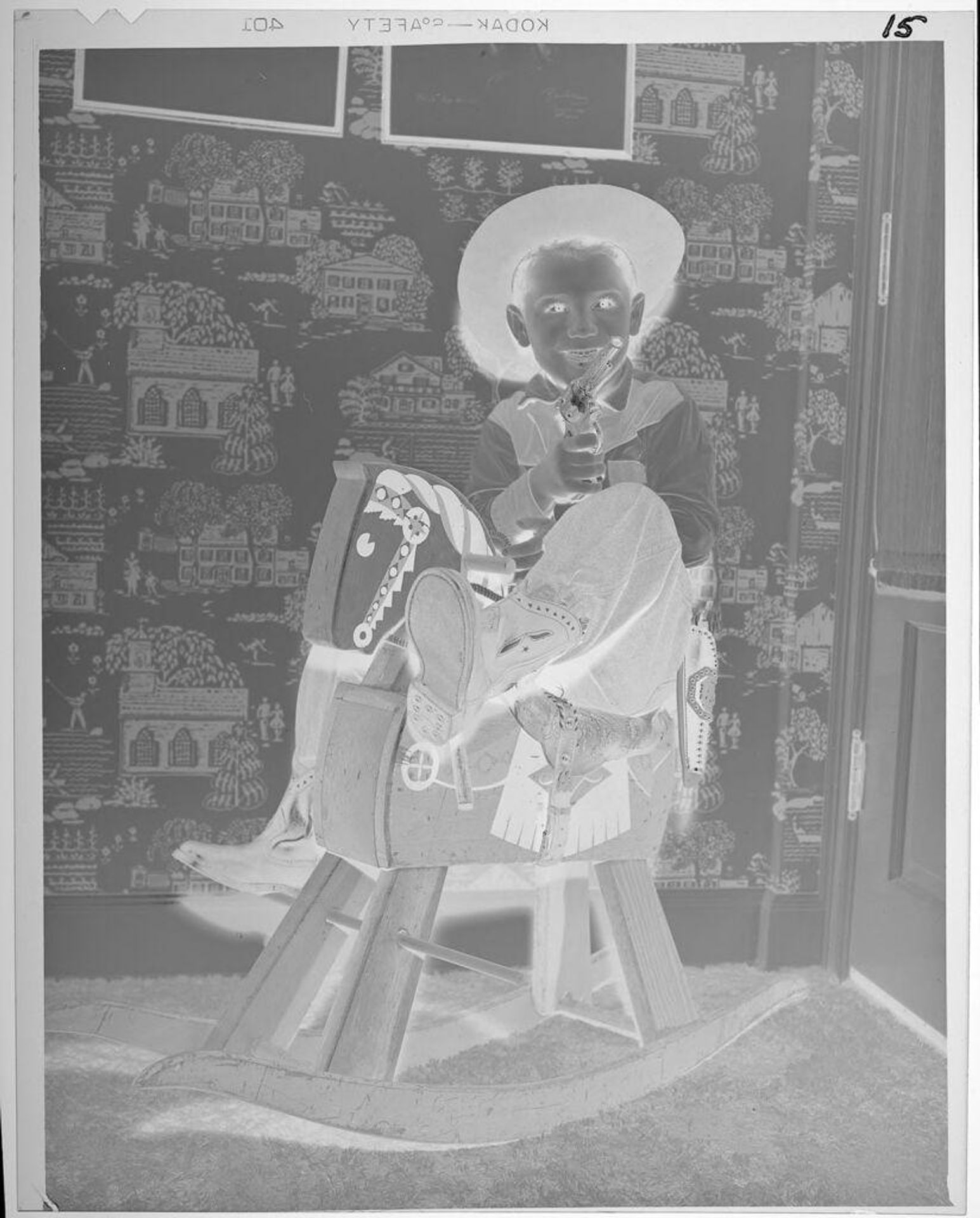 Untitled (boy in cowboy costume on rocking horse) by Lucian and Mary Brown