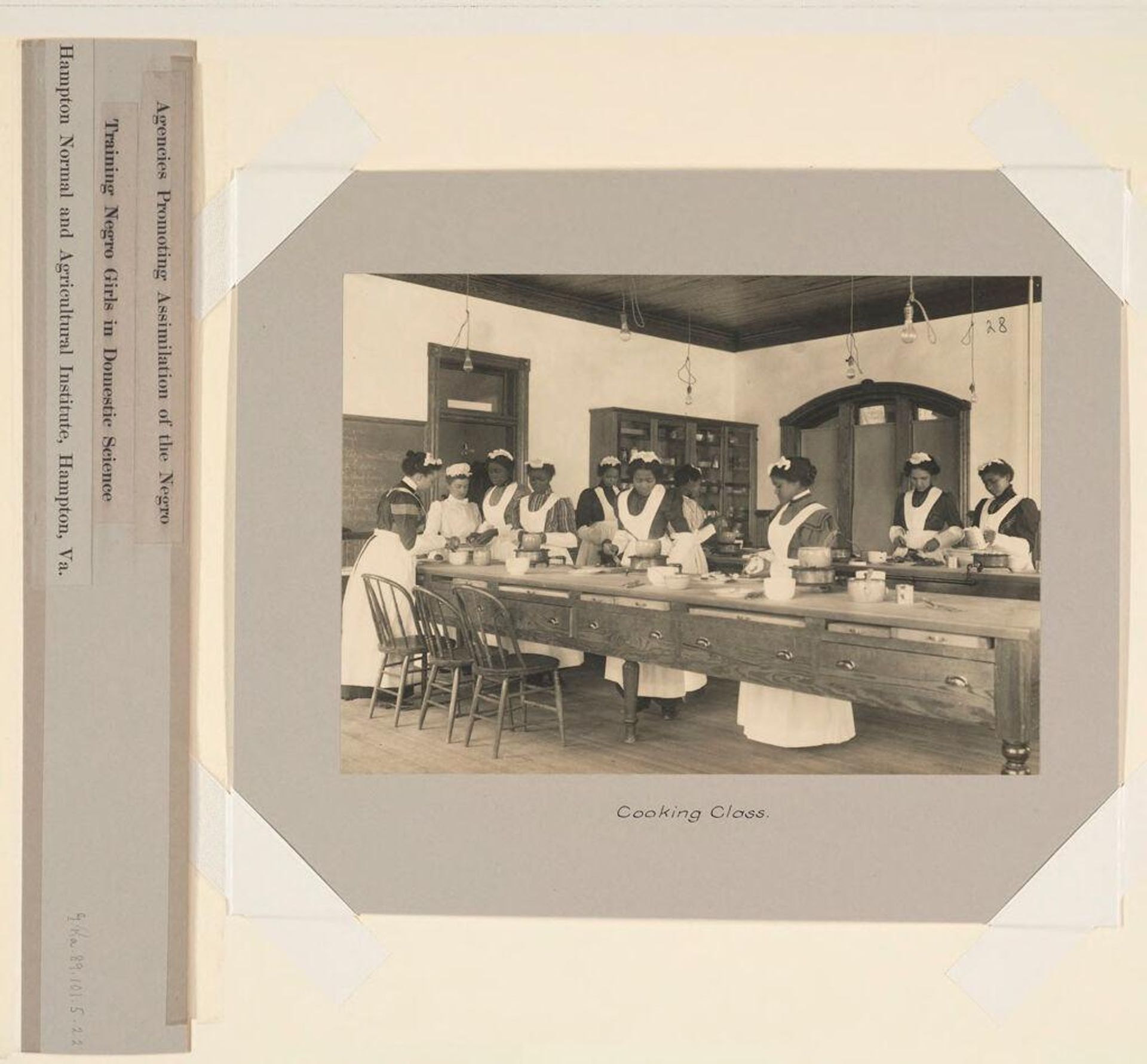 Races, Negroes: United States. Virginia. Hampton. Hampton Normal and Industrial School: Agencies Promoting Assimilation of the Negro. Training Negro Girls in Domestic Service. Hampton Normal and Agricultural Institute, Hampton, Va.: Cooking Class. by Frances Benjamin Johnston
