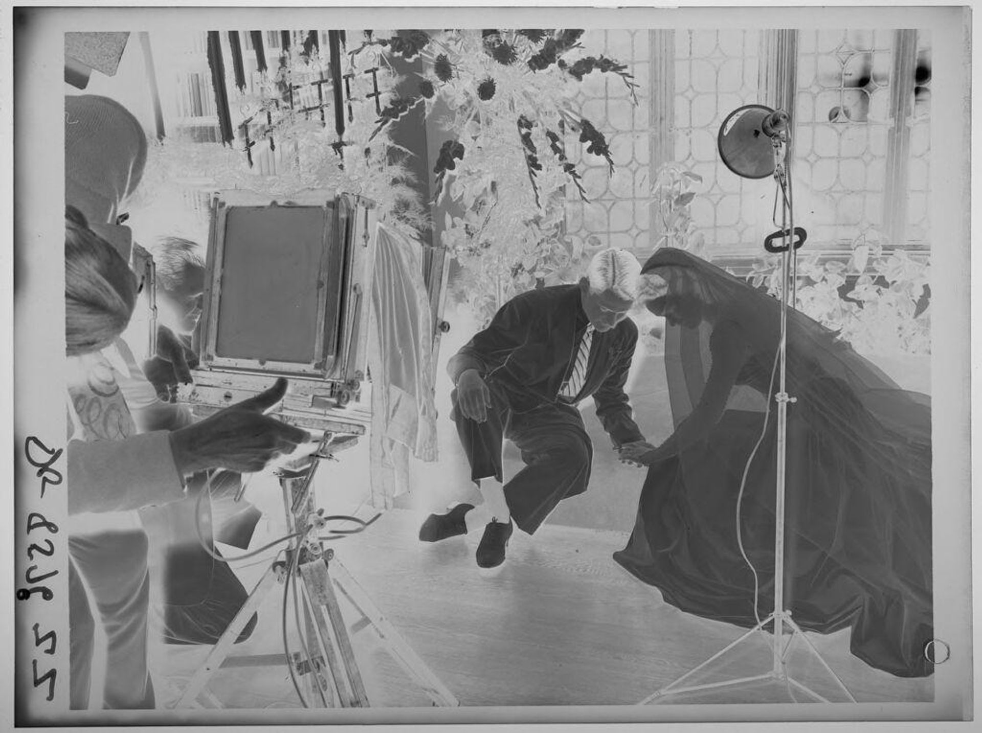 Untitled (photographer and cameras setting up pose with bride and groom) by Paul Gittings
