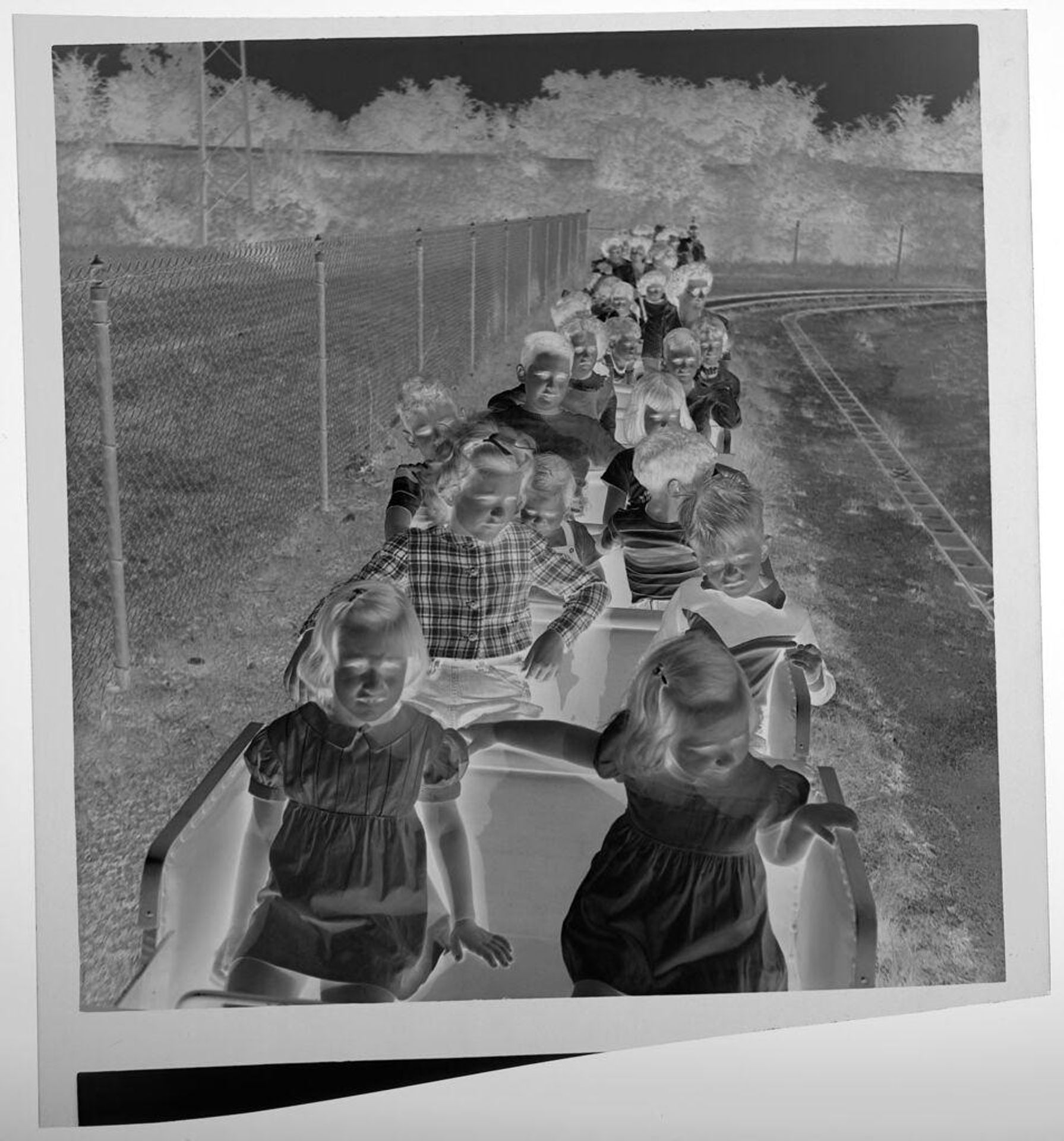 Untitled (children riding flat roller coaster at amusement park) by Jack Gould