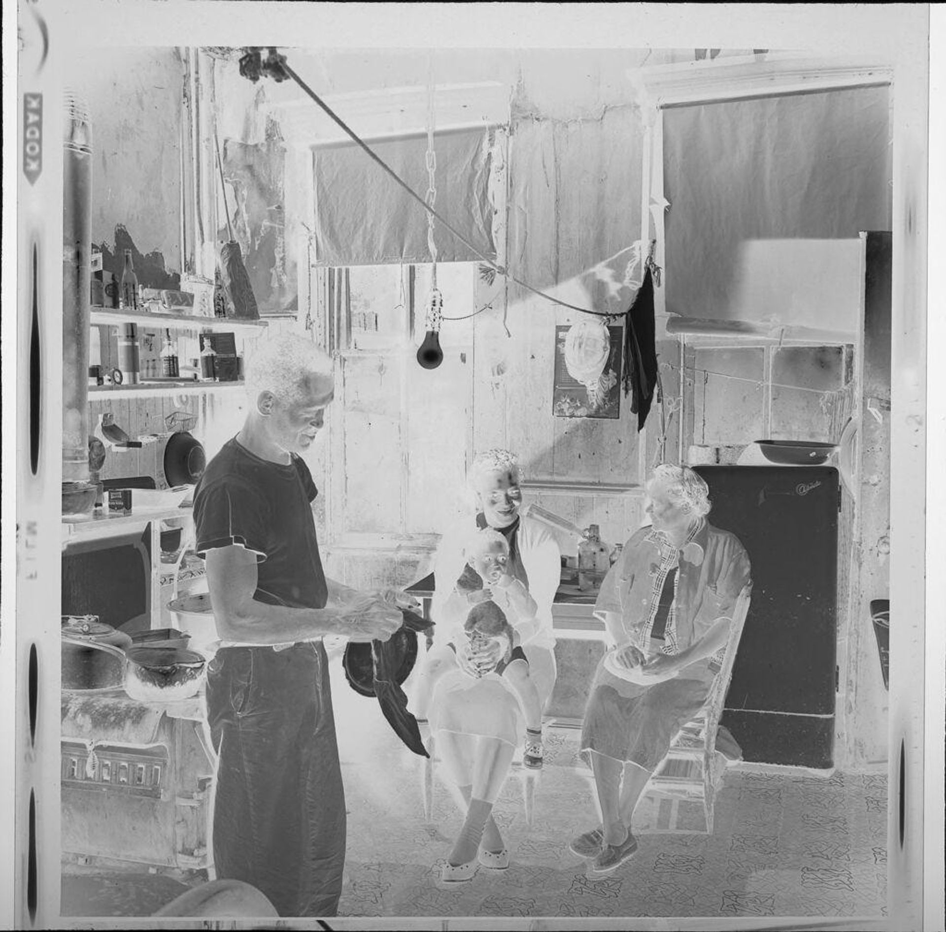 Untitled (family inside run-down house) by Jack Gould