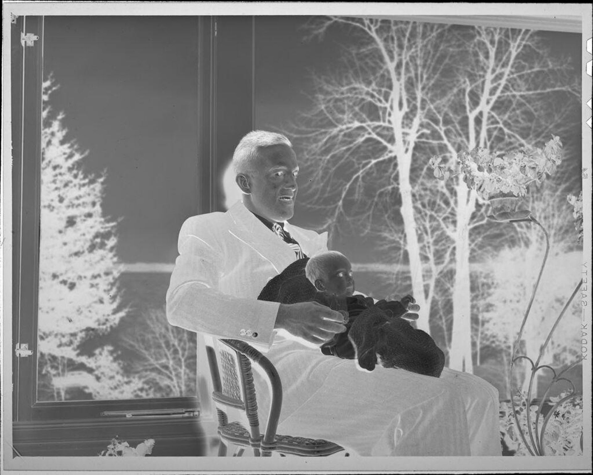 Untitled (man holding baby) by Lucian and Mary Brown