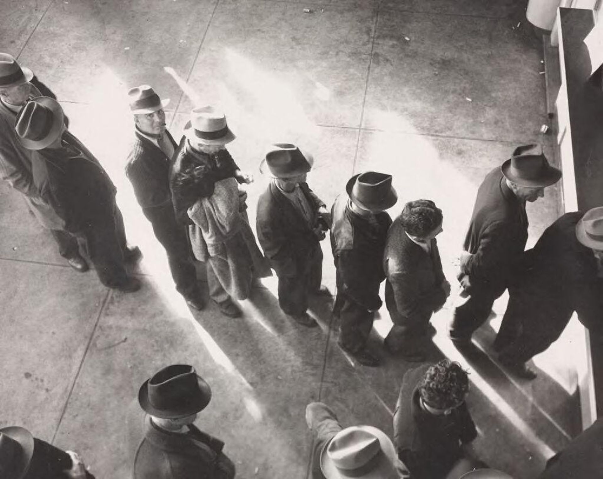 Unemployment benefits aid begins. Line of men inside a division office of the State Employment Service office at San Francisco, California, waiting to register for benefits on one of the first days the office was open. They will receive from six to fifteen dollars per week for up to sixteen weeks. Coincidental with the announcement that the federal unemployment census showed close to ten million persons out of work, twenty-two states begin paying unemployment compensation by Dorothea Lange