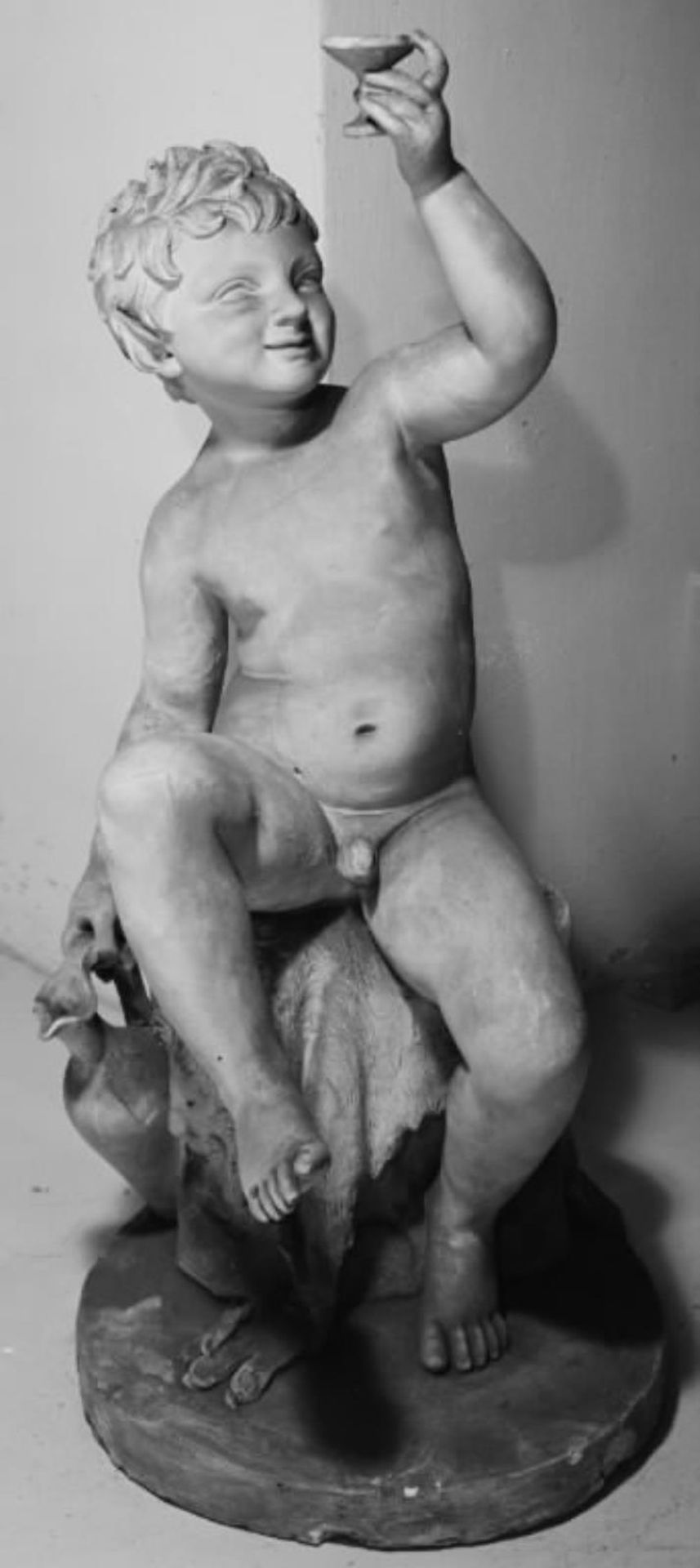 Et bacchusbarn med et vinglas, siddende på en klippeblok by C.F. Holbech