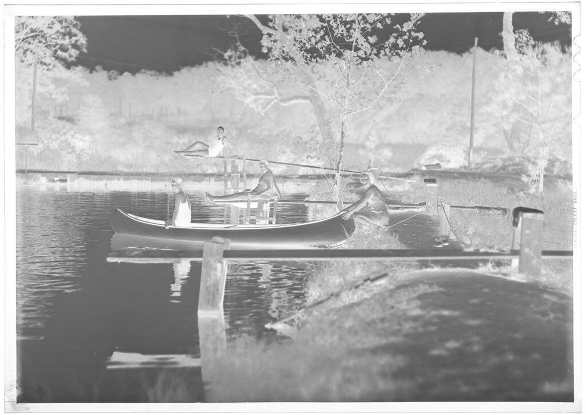 Untitled (girl scouts posing in swimsuits with canoe) by Hamblin Studio