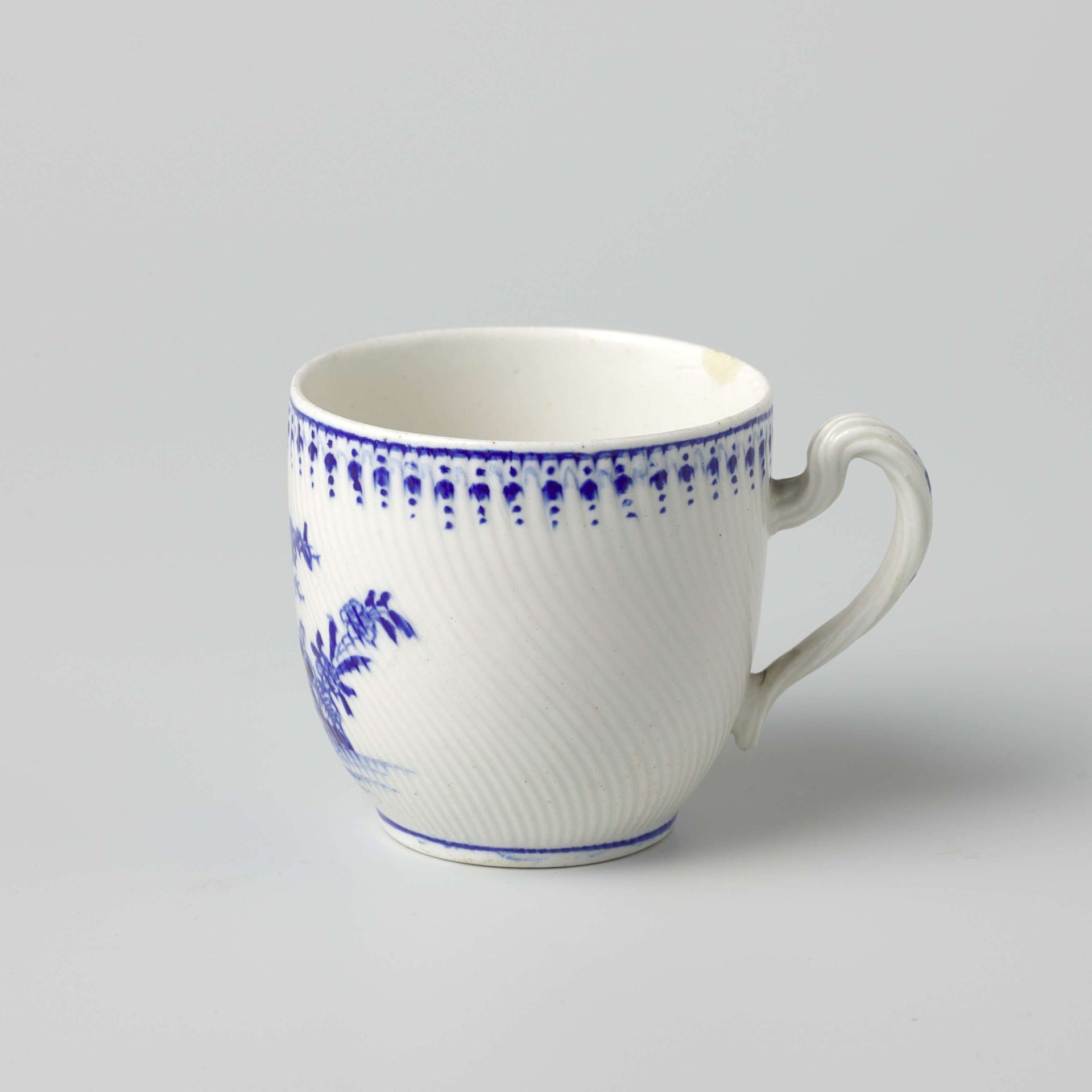 Cup with flowering plants by Doornik