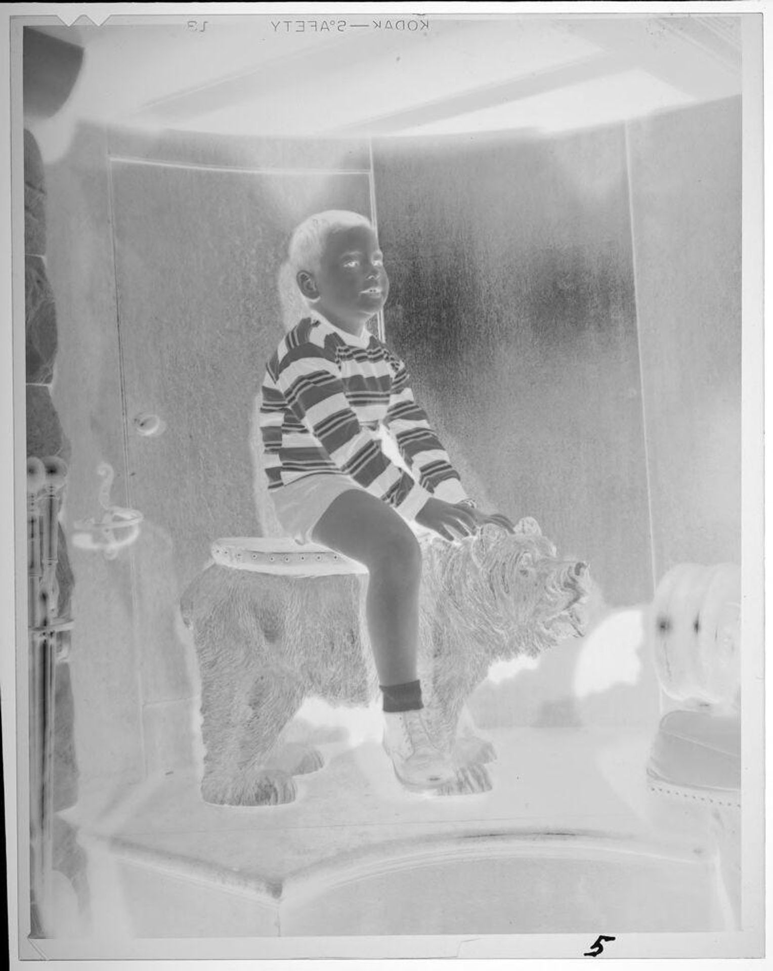 Untitled (boy riding fake animal) by Lucian and Mary Brown