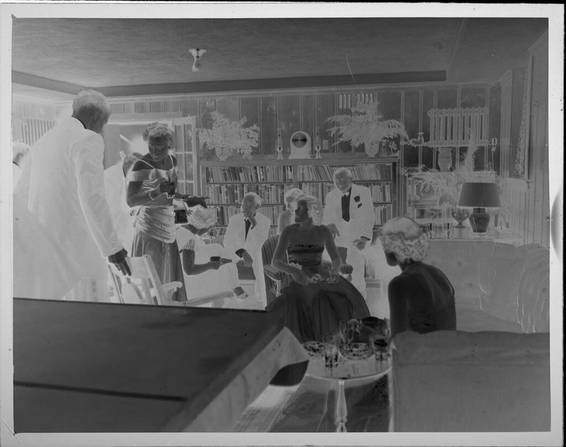Untitled (people at party in living room) by Lucian and Mary Brown