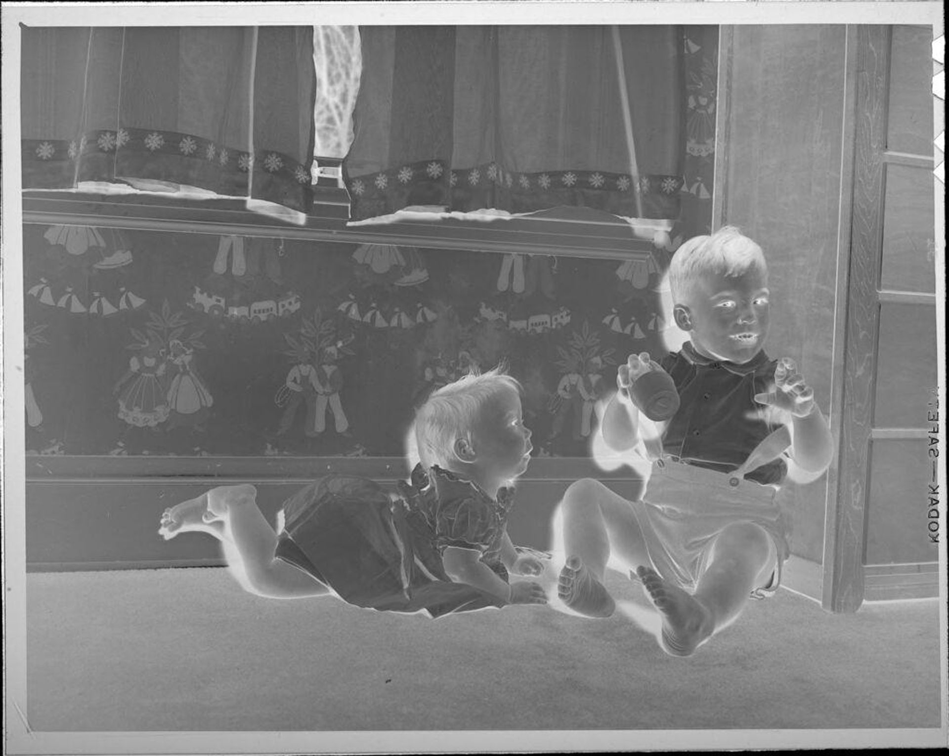 Untitled (two children playing on floor) by Lucian and Mary Brown