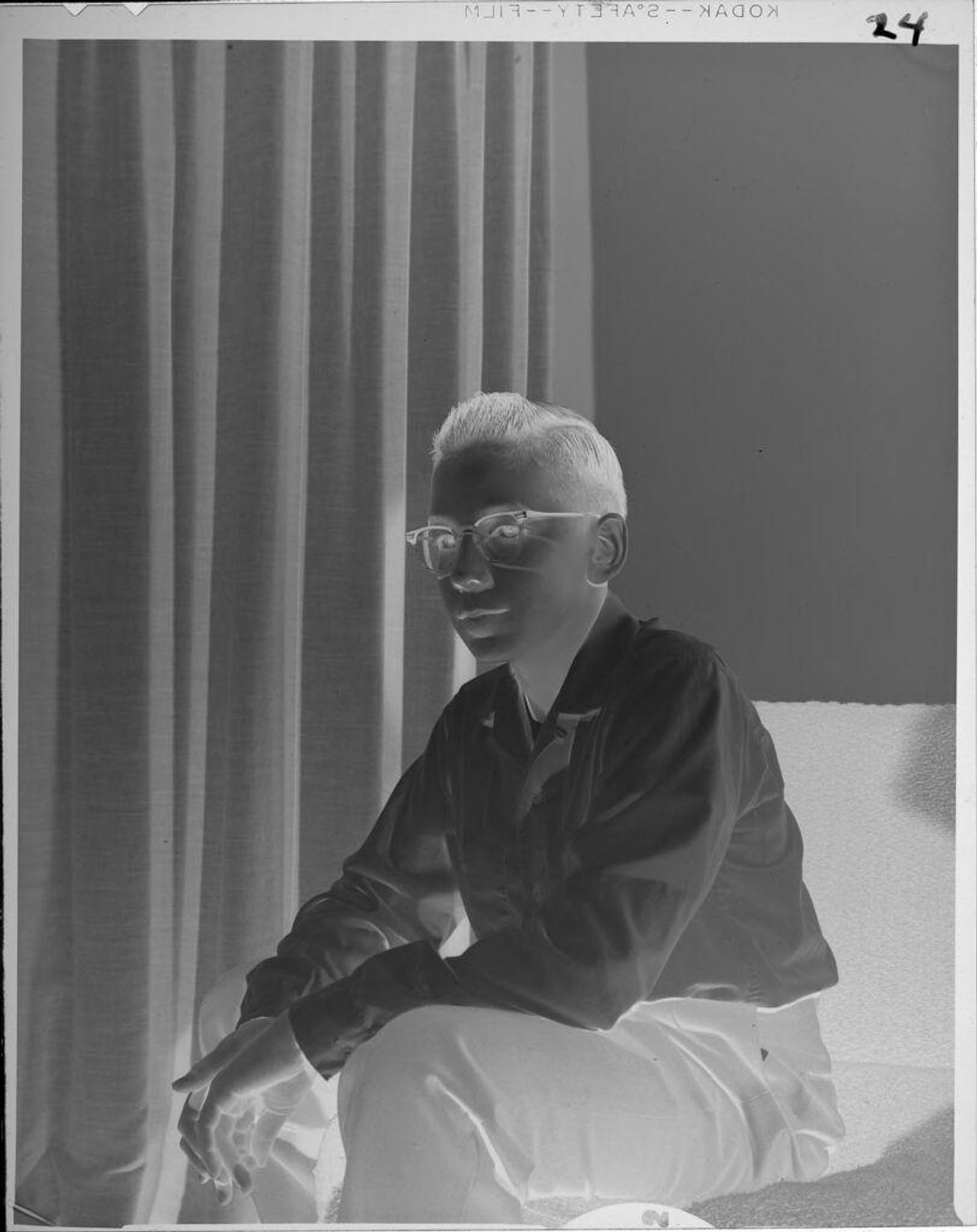 Untitled (seated boy wearing glasses) by Lucian and Mary Brown