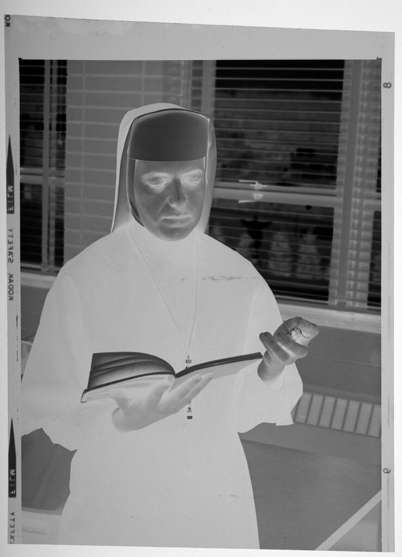 Untitled (nun reading book inside school room) by Martin Schweig