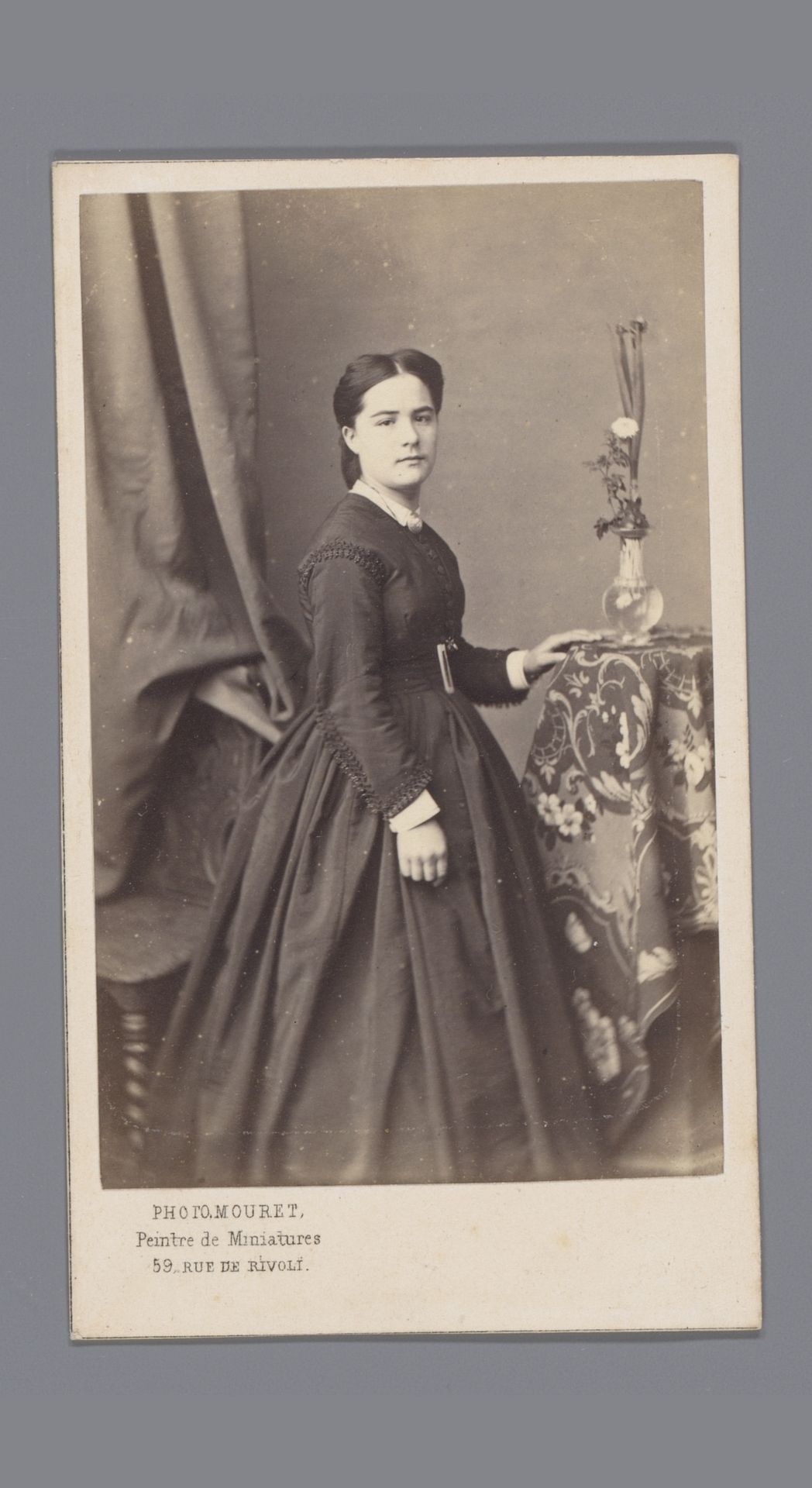 Portret van een onbekende vrouw bij bloementafel by Achille Ernest Mouret
